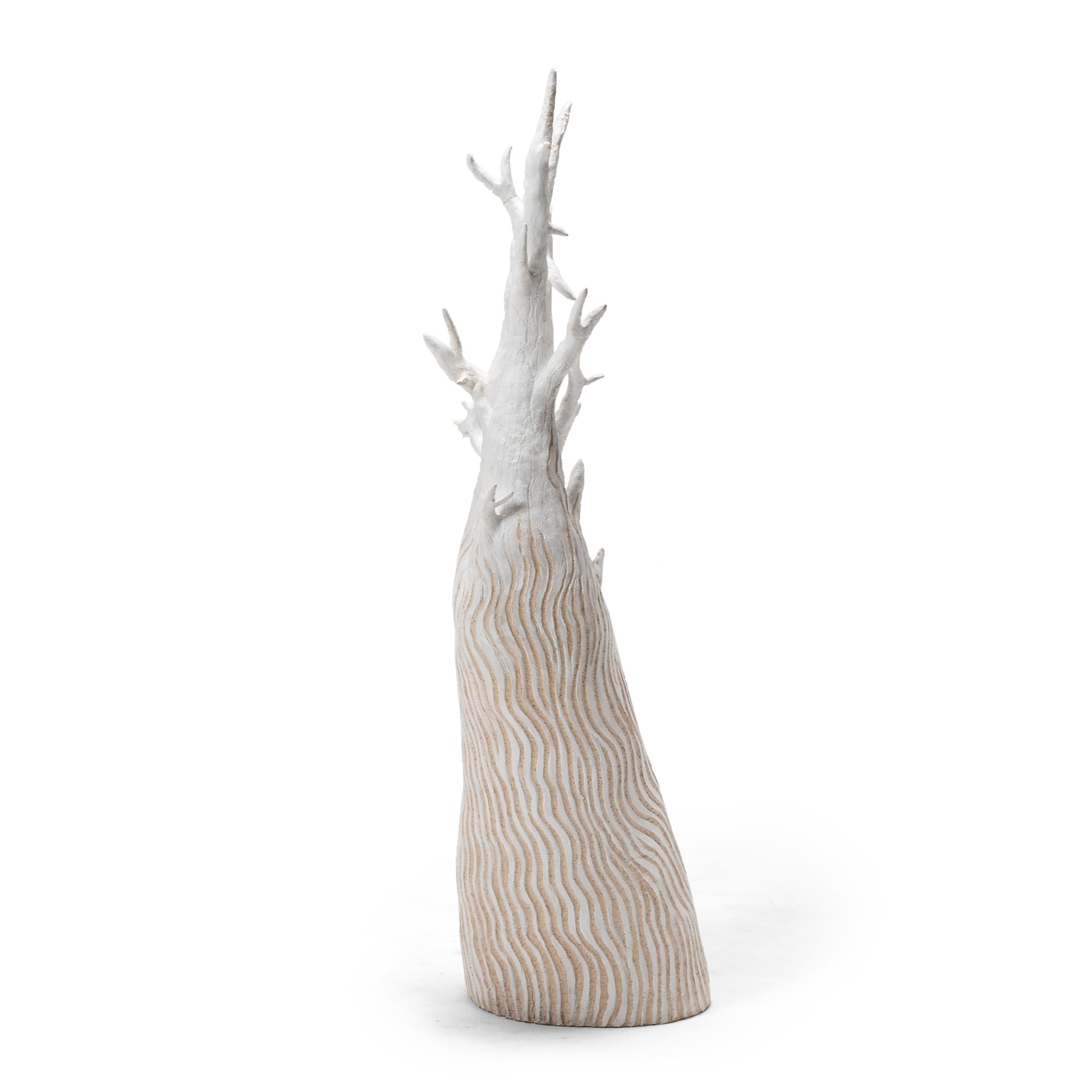Decorated with meandering incised linework, this sculptural ceramic tree is a playful way to add texture and contrasting color to any interior. We love the petite tree as a display for hanging objects or a whimsical centerpiece.