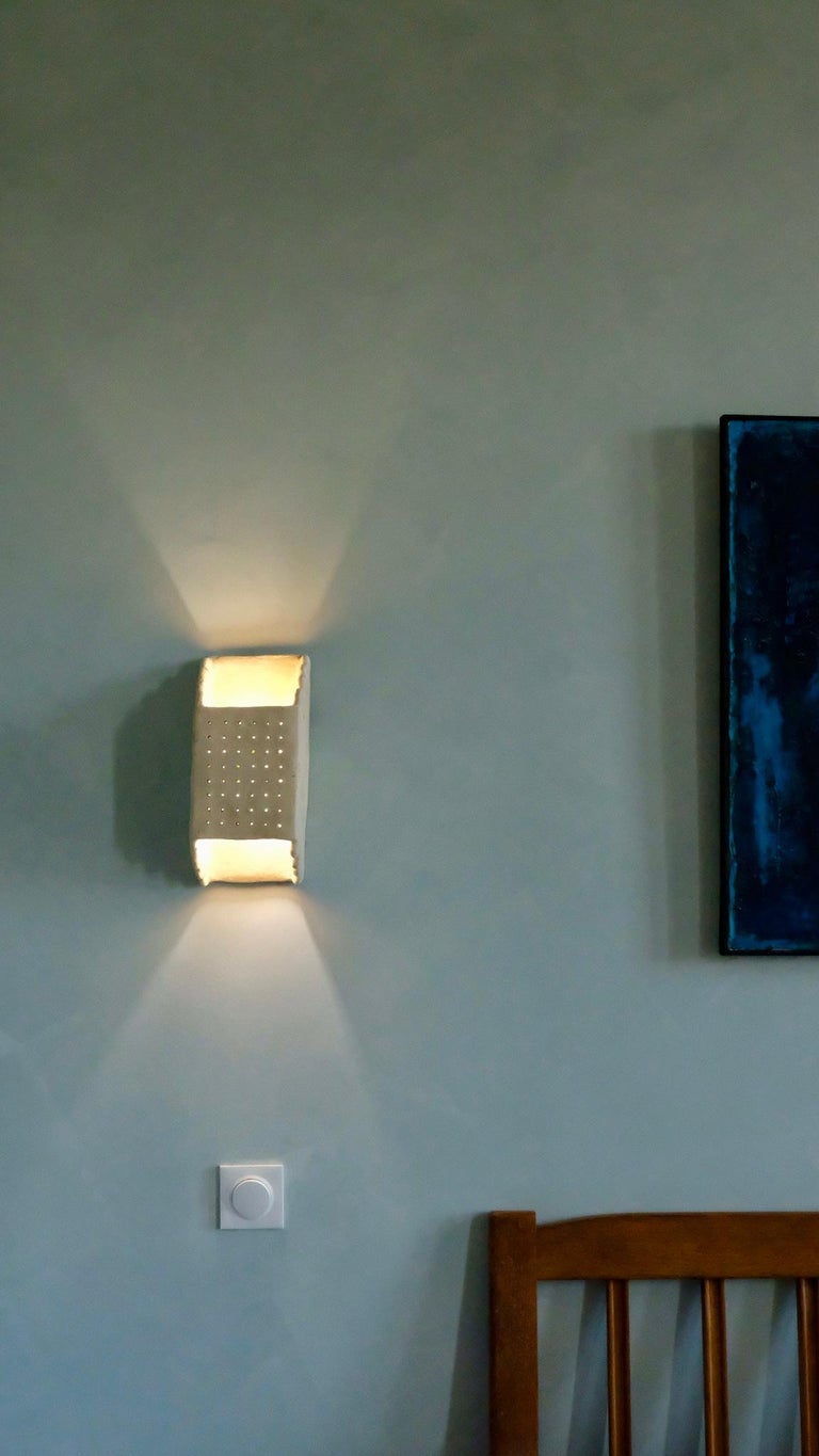 - Handbuilt white ceramic wall light
- made of clay collected from the potter's surroundings.
- made in the Moroccan Rif mountains by the potter Houda.
- co-created by the potter Houda x memòri team
- small scale-production

Approximate