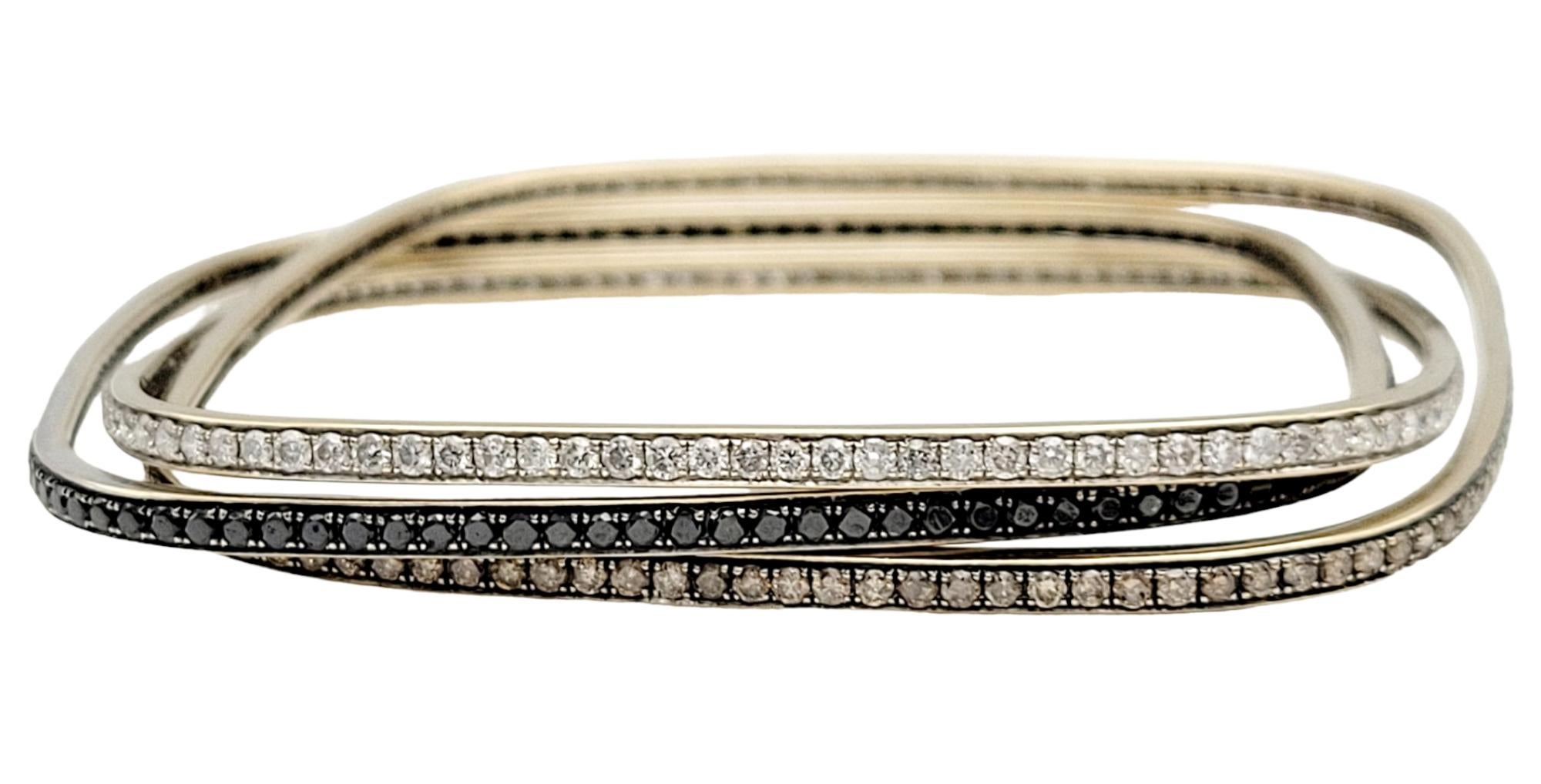 We absolutely love this fabulously stacked sparkling diamond bangle set! Simple yet stunning, the multi-toned natural diamonds wrap the wrist in contemporary elegance. 

Featured here is a trio of square shaped diamond bangles. Each bangle is unique