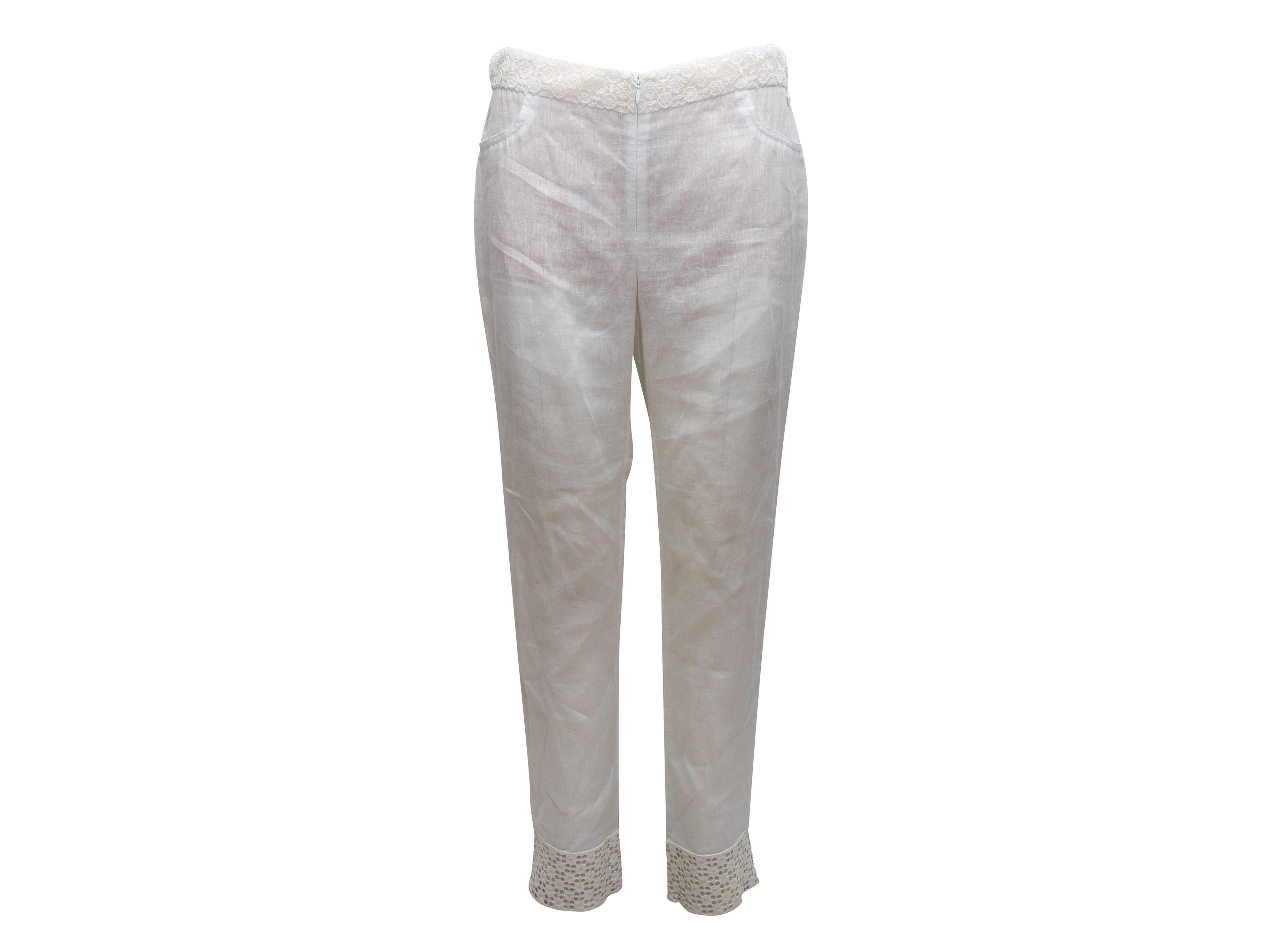  White linen lace-trimmed skinny pants by Chanel. Dual hip pockets. Front zip closure. 32