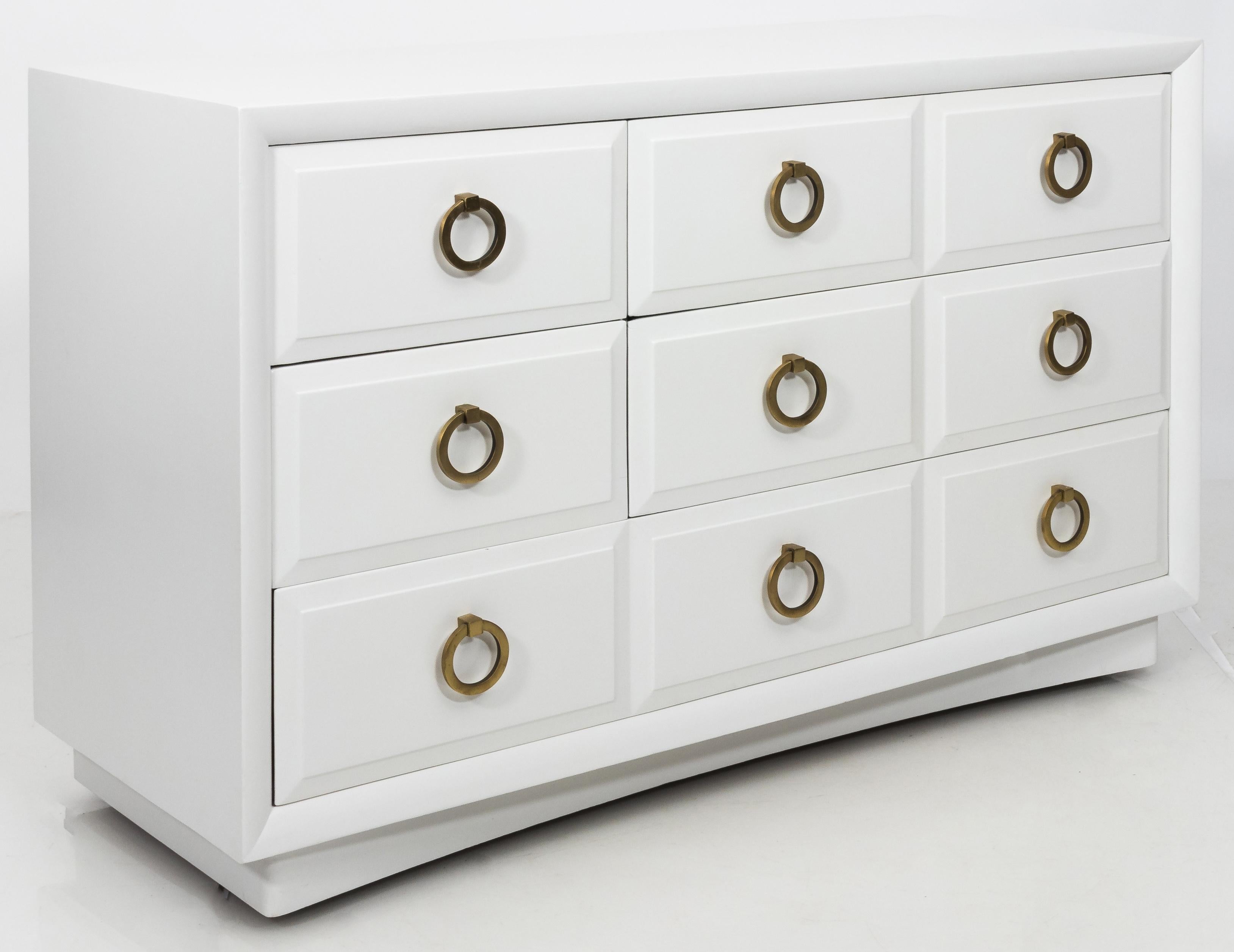 Chest of drawers by T.H. Robsjohn-Gibbings for Widdicomb. Five-drawer style. Dresser is newly refinished in satin white paint with original satin brass ring pulls. Stamped Widdicomb inside top drawer. Top left drawer has removable divided storage.