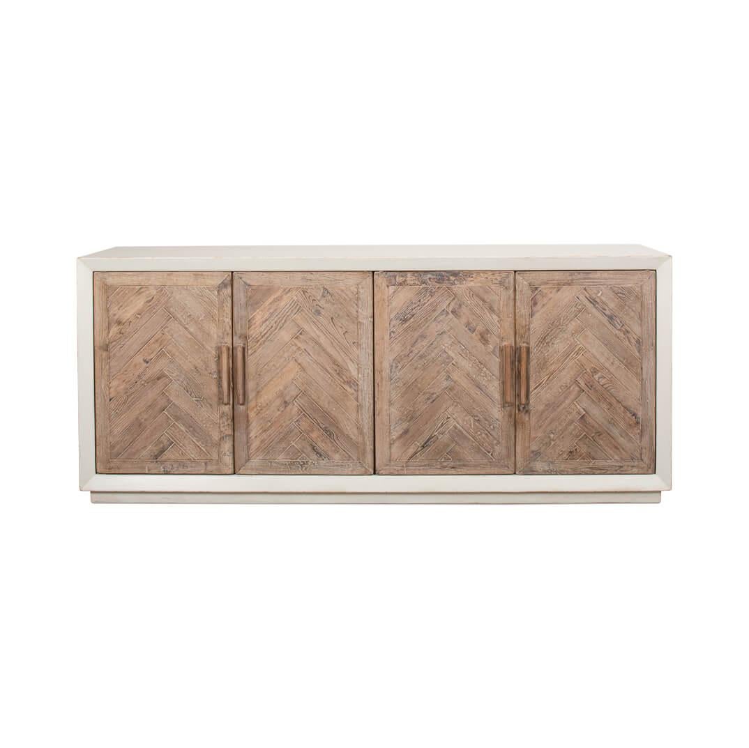 This cabinet showcases the natural allure of reclaimed pine, finished by hand in a nuanced antique white that tells of whispered elegance and earthy charm. Its doors, graced with a chevron pattern, open to a world where your treasures are kept safe