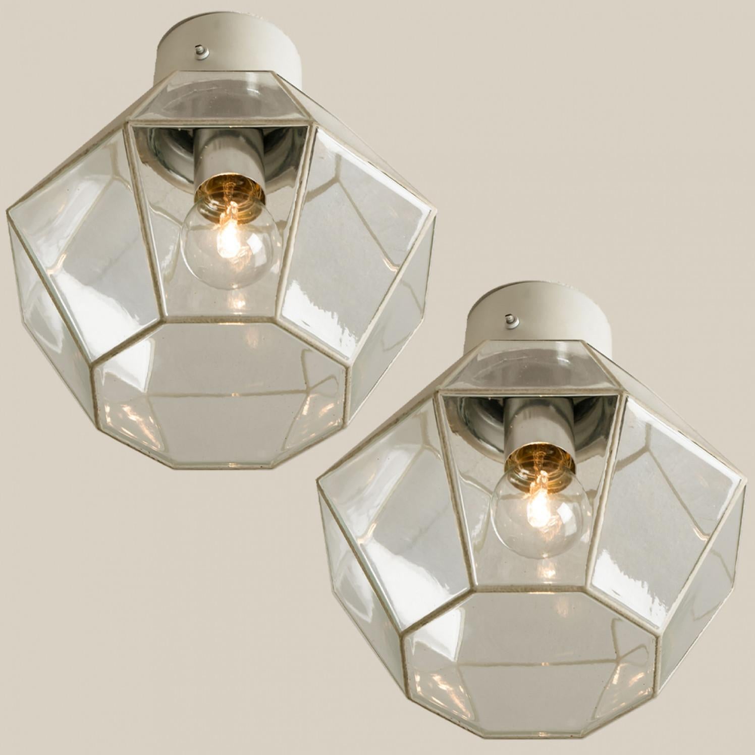A beautiful set of octagonal glass light flush mounts or wall lights, manufactured by Glasshütte Limburg in Germany during the 1970s. Beautiful craftsmanship. Illuminates beautifully.

Please note the price is for one piece. Two pieces