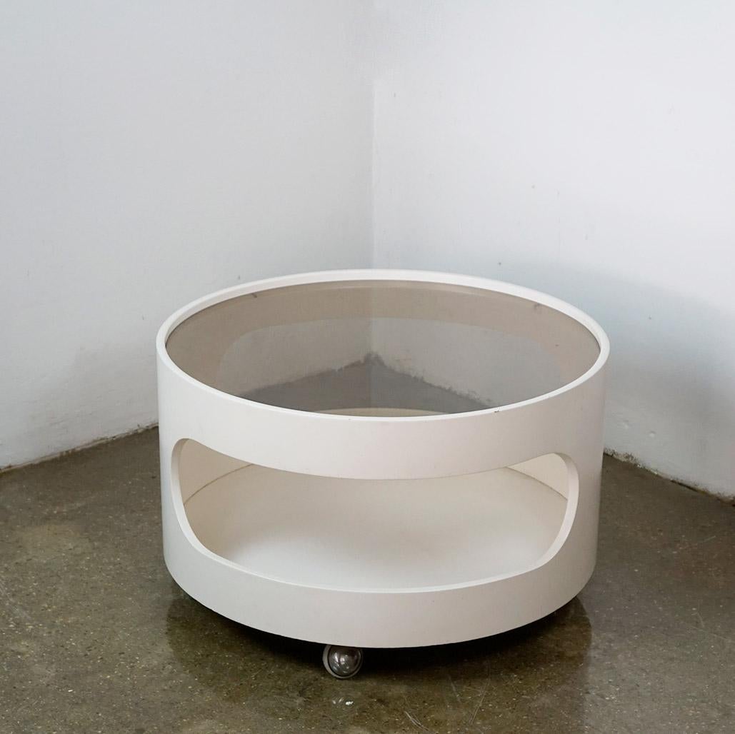 Charming white lacquered circular Space Age coffee table with smoked glass top on wheels in very nice condition. 
It has been designed and produced in Germany by Opal Kleinmöbel in the late 1960s and shows the original manufacturers mark on the