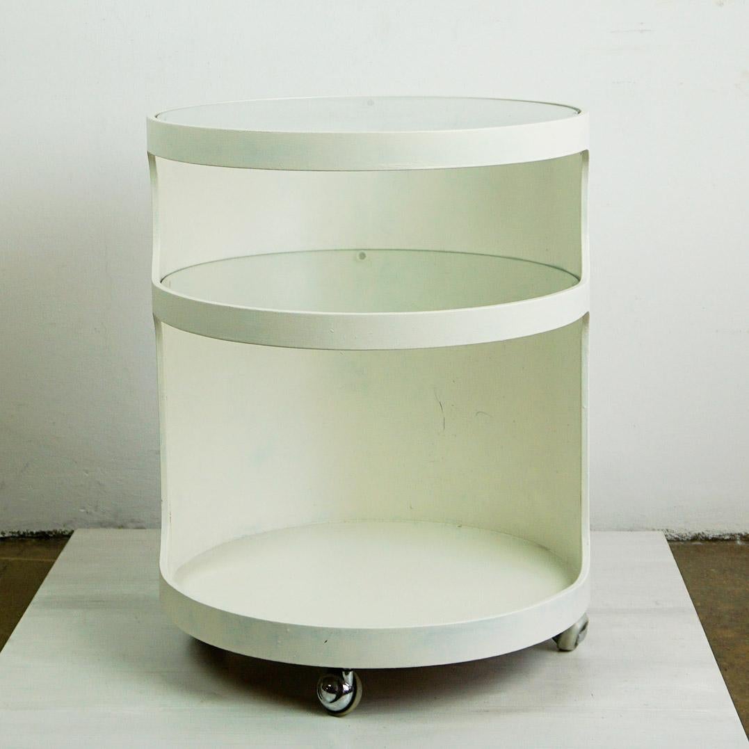 This Charming white lacquered circular Space Age Bar Trolley, Side Table or serving Cart has been designed and produced in Germany by Opal Kleinmöbel in the late 1960s .It features two smoked glass tops on wheels and is in very nice condition. It
