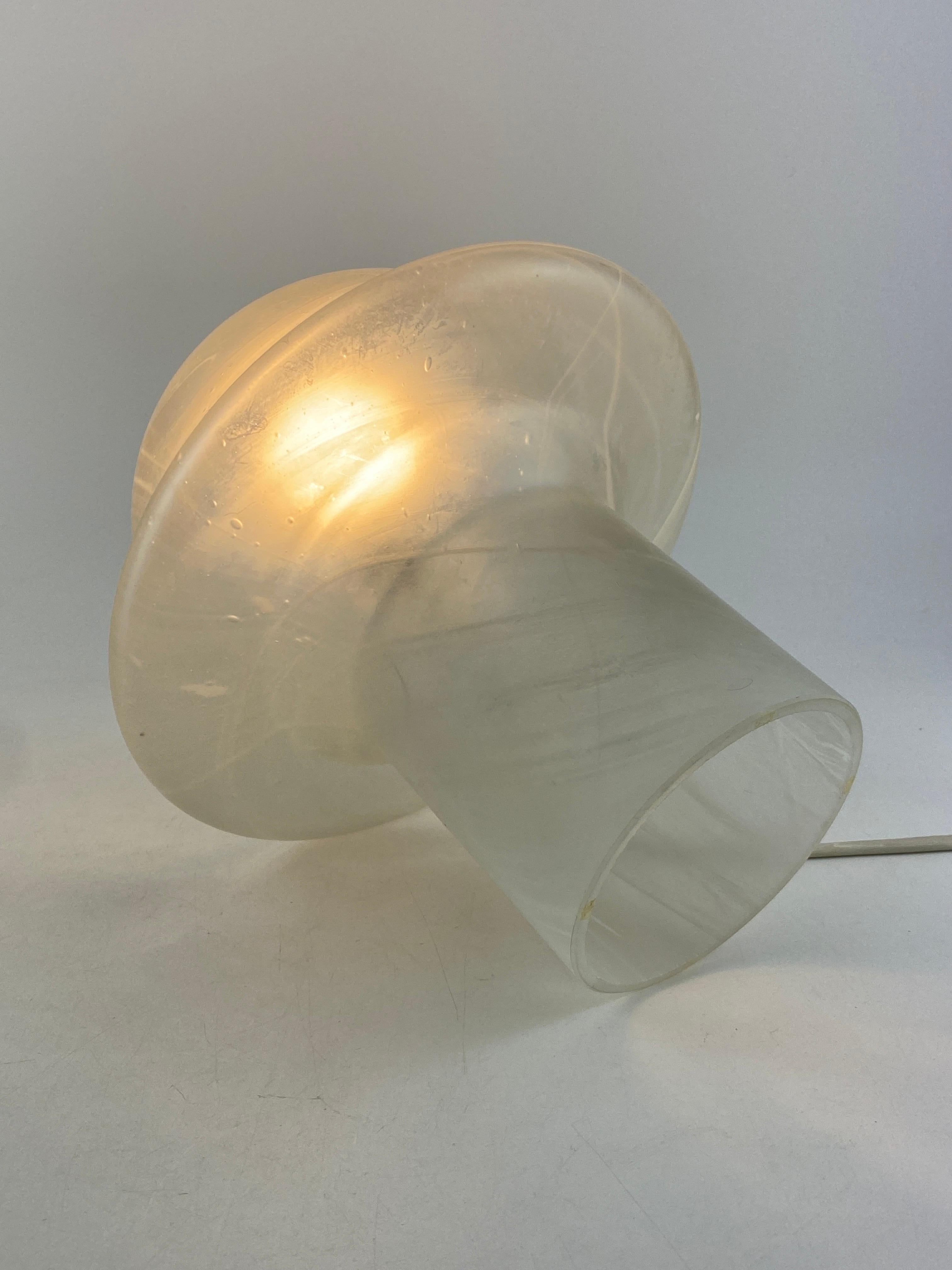 Beautiful German design by Peill and Putzler, produced around 1970 - 1980.

This lamp is made of one mouth-blown piece of clear crystal glass, that's why every piece is unique. It has a striped print and it's shaped like a typical mid-century