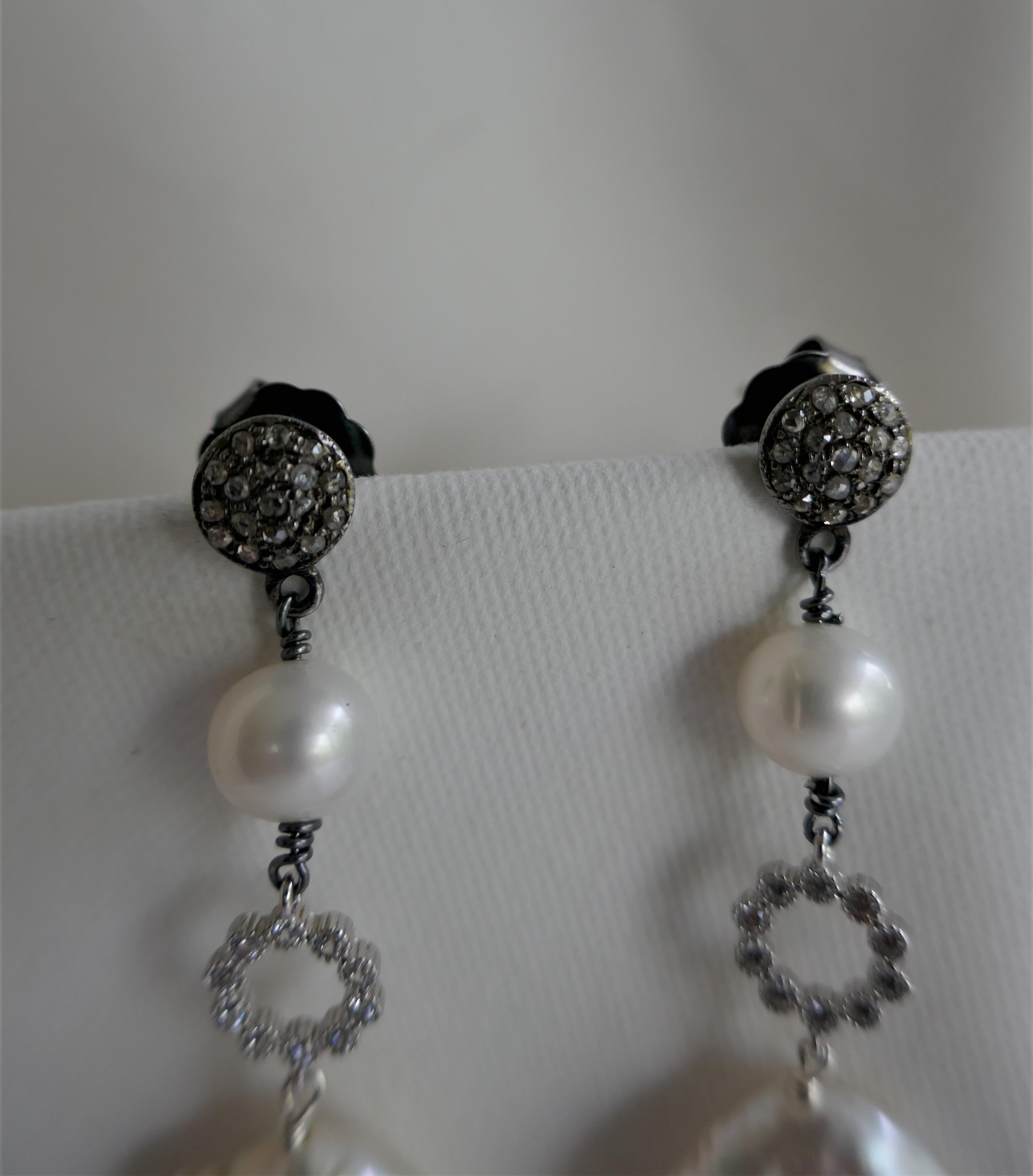 Great earrings. The earrings 13mm white coin cultured pearls that hand 925 sterling silver cubic zirconia bead and 7.5mm almost round white cultured pearls. The post is 925 oxidized silver and diamonds 8mm push back. These earrings can be dressed up