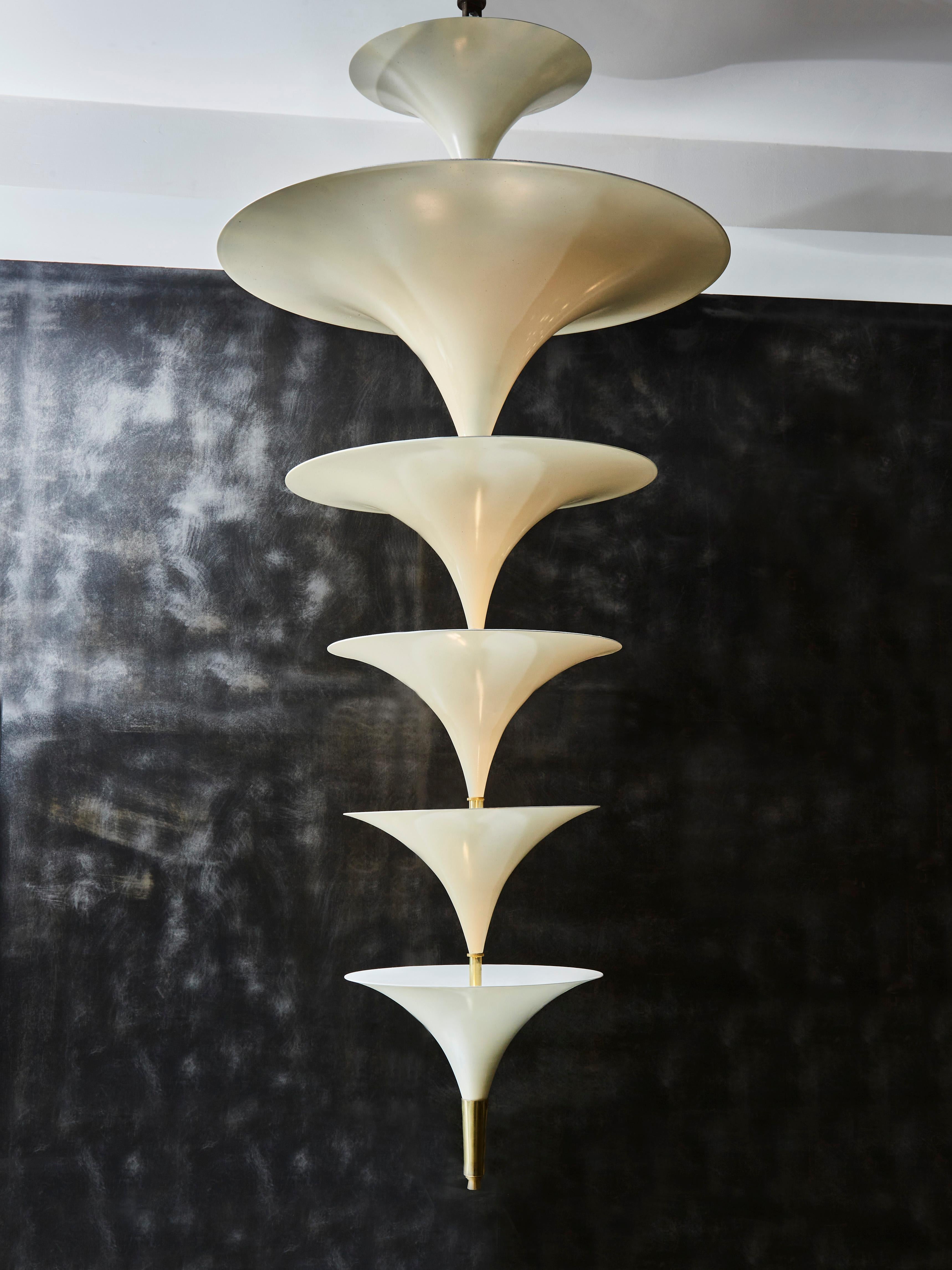 Vintage chandelier made of a stack of different sized cones, made of white enameled metal.

Two lights between each cones giving a powerful indirect lighting.


A pair of chandeliers available, displayed price for one.