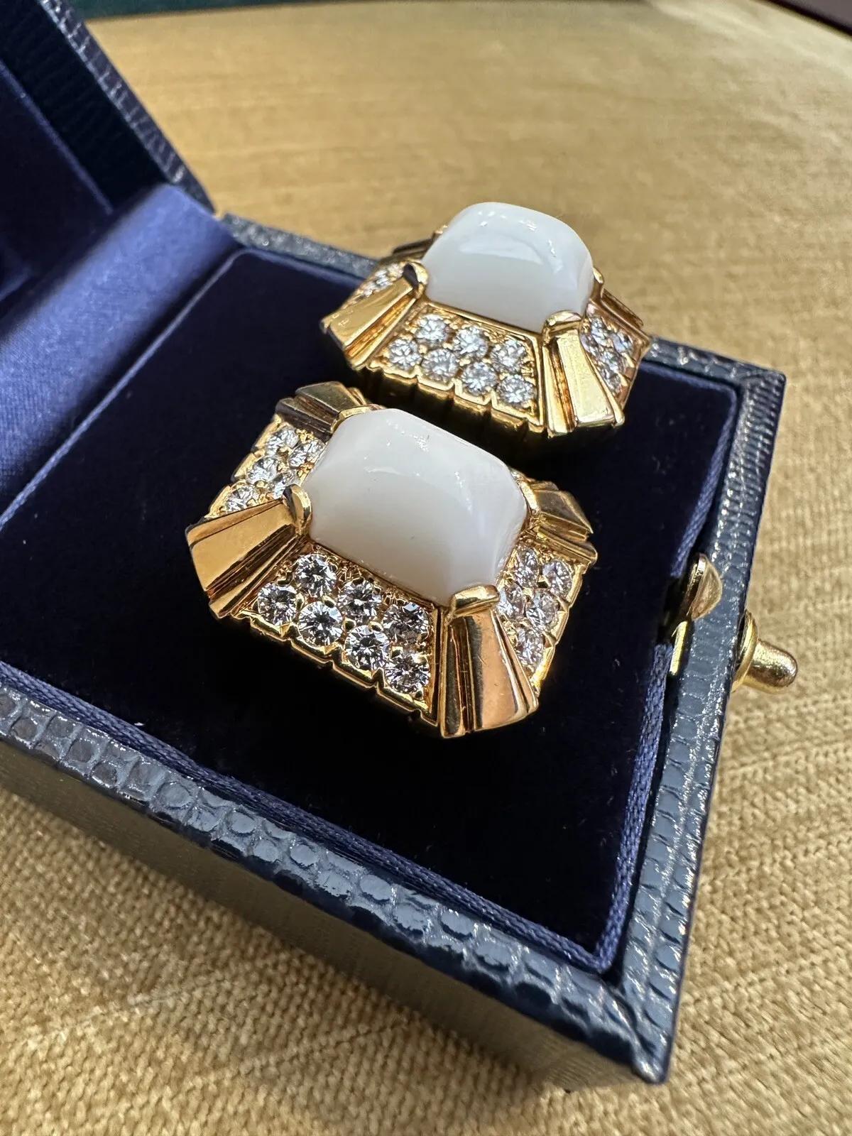 White Coral and Diamond Clip on Earrings in 18k Yellow Gold 

Diamond and White Coral Earrings feature a large Rectangular White Coral Cabochon surrounded by 2 Rows of Round Brilliant Diamonds, all set in high polished 18k Yellow Gold. Earrings are