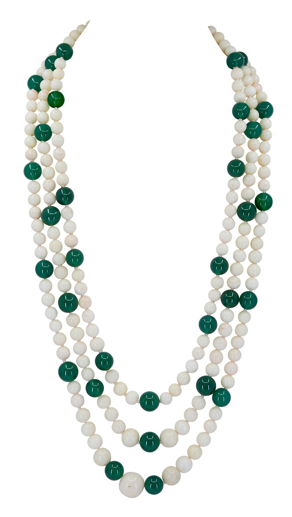 A 3 strand Green Onyx and White Coral necklace that measures 24, 26, and 30 inches in length and is made up of Natural untreated White Coral beads that measure from 7.5-15mm each offset by 12.5mm Lustrous Green Onyx beads. $3,600
