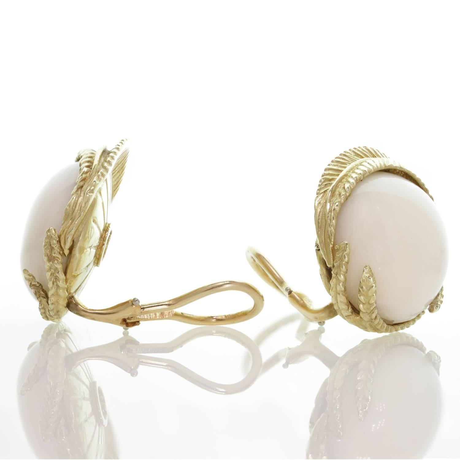 These fabulous clip-on earrings feature 17.0mm round natural white corals set in yellow gold. Circa 1960s. Measurements: 0.94