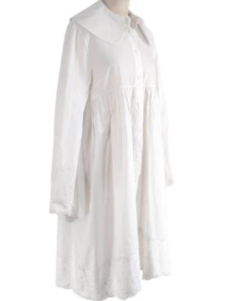 Simone Rocha white cotton cherub embroidered Puritan collar dress
 
 - Cotton day dress with oversized Puritan collar
 - Empire waistline, and oversize silhouette
 - Trimmed with cherub embroidered Broderie Anglaise
 - Unlined 
 
 Materials 
 100%