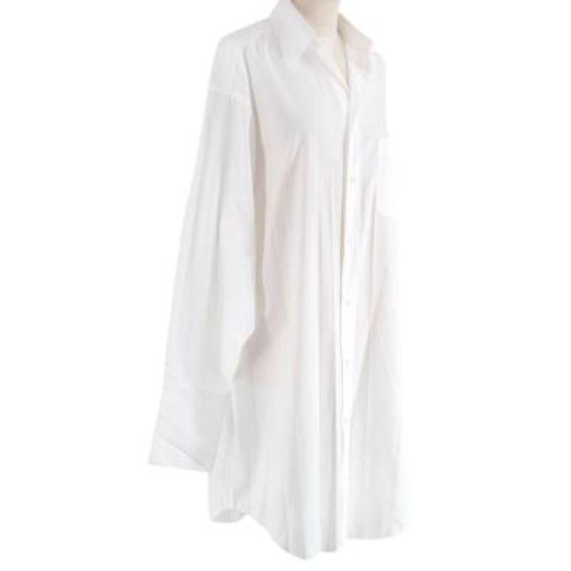 Balenciaga white cotton poplin oversize shirt
 
 
 
 - Longline cotton shirt, with exaggerated proportions, a house signature for Balenciaga
 
 - Classic collar, button front
 
 - Long sleeves, double-height buttoned cuffs
 
 - Breast pocket with