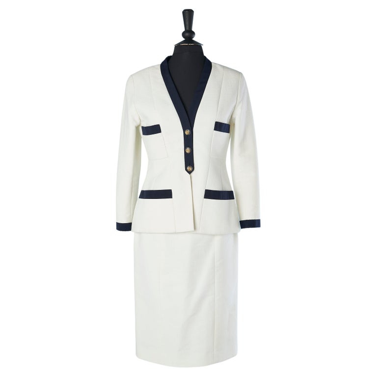 White cotton skirt-suit with navy gros-grain piping and camellia's