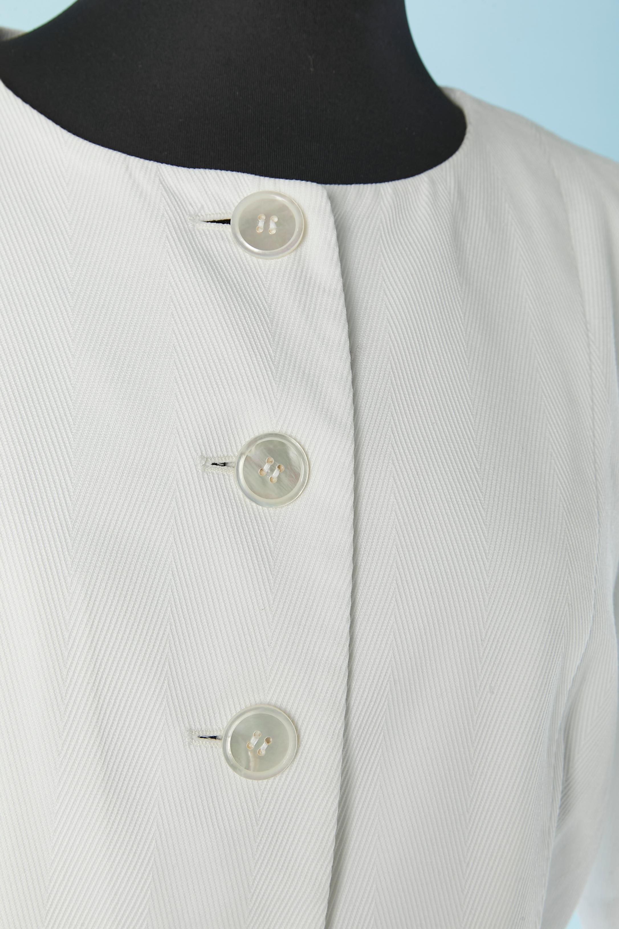 White cotton skirt suit. Rayon lining. 
Shoulder pad. Button and buttonhole on the middle front. Half-belt on both side with button and buttonhole.
SIZE 44 (Fr) L 