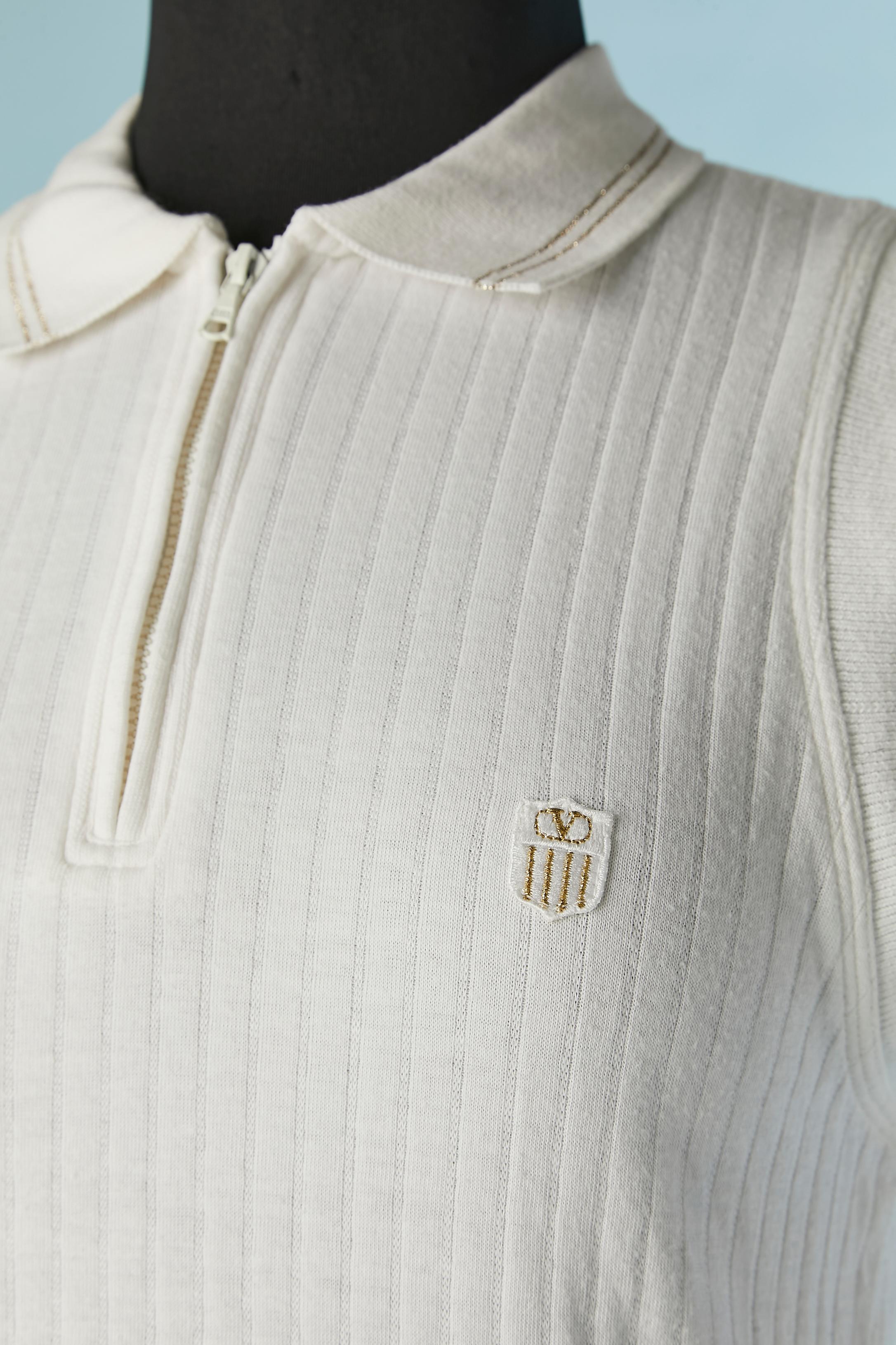 White jersey cotton sleeveless Tennis mini-dress.Zip closure on the top middle front. 
Thin ligne in gold lurex on the collar. 
SIZE S/M 