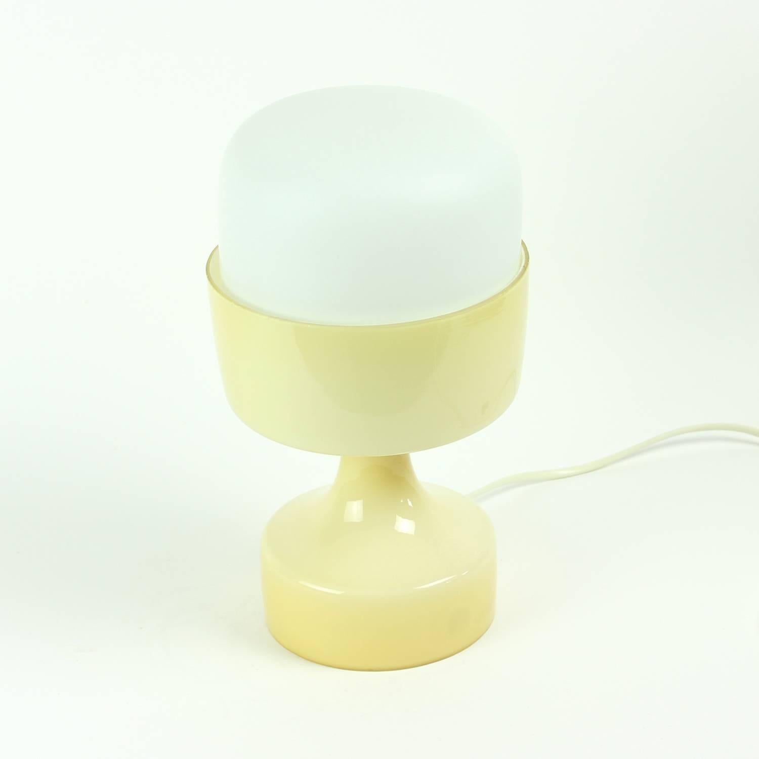 Beautiful and rare table lamp designed by Czech designer Ivan Jakes for Osvetlovací Sklo. Made of two pieces of opaline glass. The top shield is of matte finished, white opaline glass, bottom part is in shiny cream colored opaline glass. The lamp is
