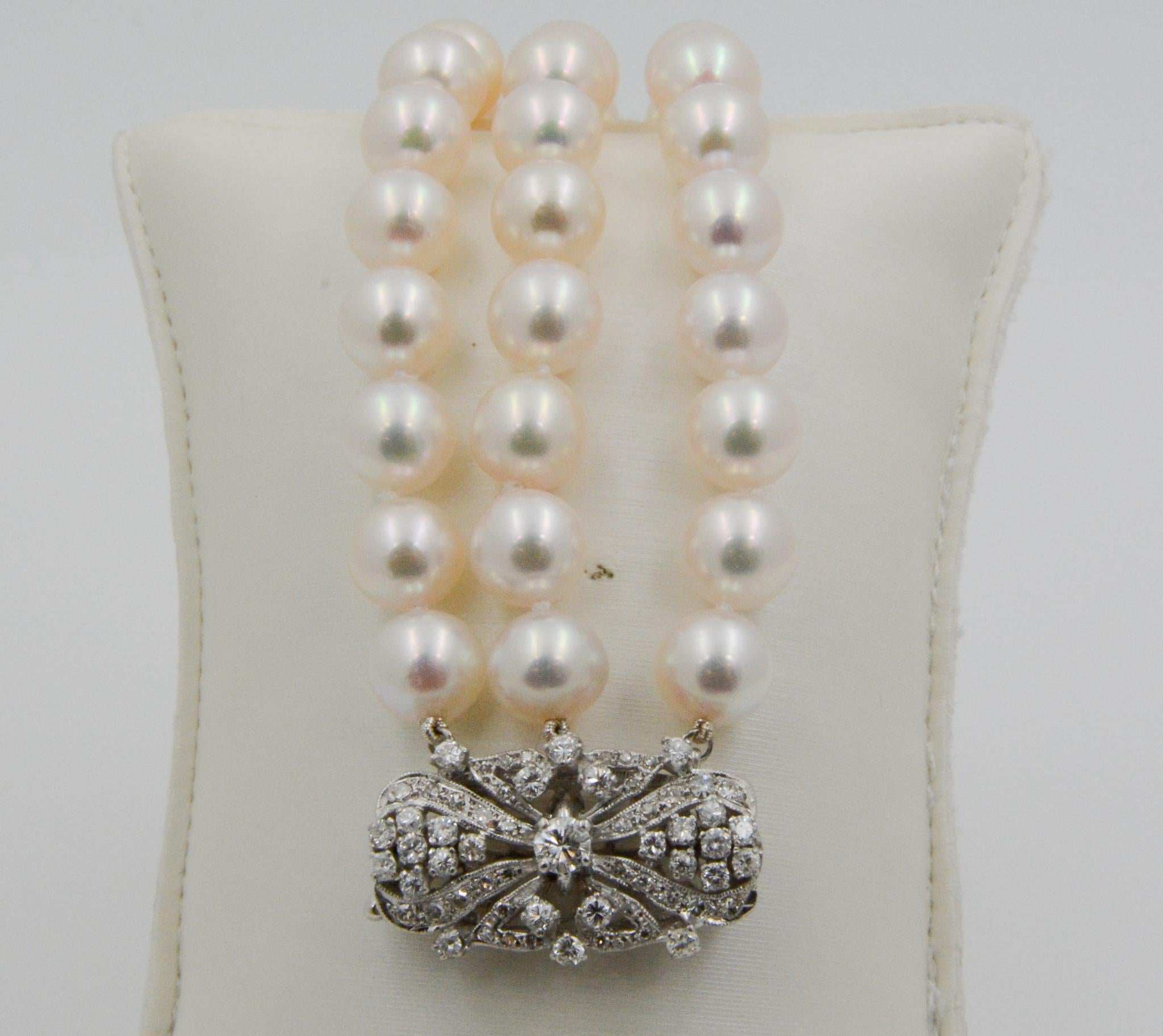 57 white cultured pearls, measuring 8x8.85mm each, are strung on three rows of this lovely bracelet. The intricate 18 karat white gold oval clasp features 27 round brilliant cut diamonds, weighing a combined 0.60 carats with H-I coloring and SI