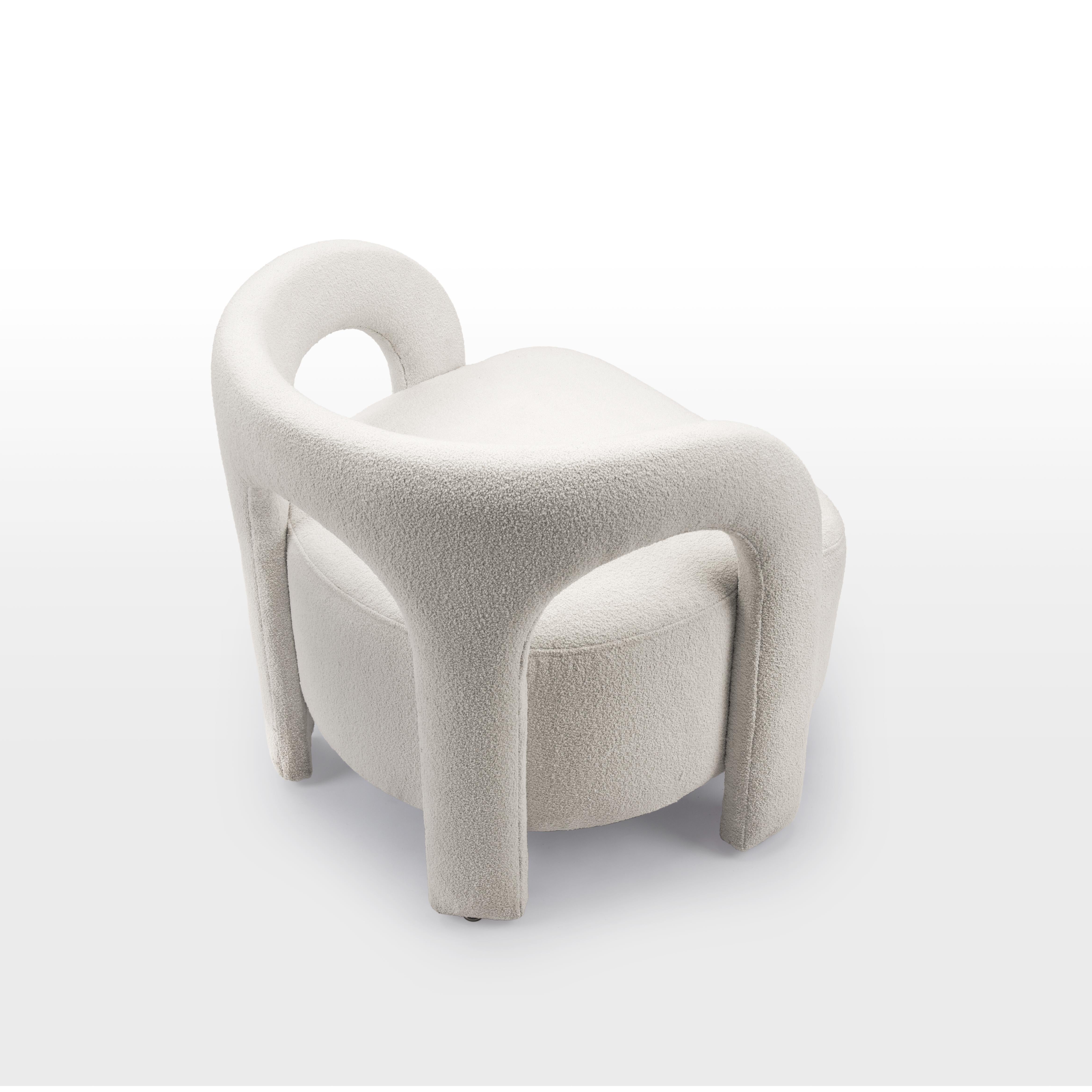 White curvy upholstered armchair inspired By Egypt's Nubian Architecture

The Nubia set is the heart of this Nubian collection. Nubian houses are typically built for entire families and are known for having an outdoor central courtyard where the
