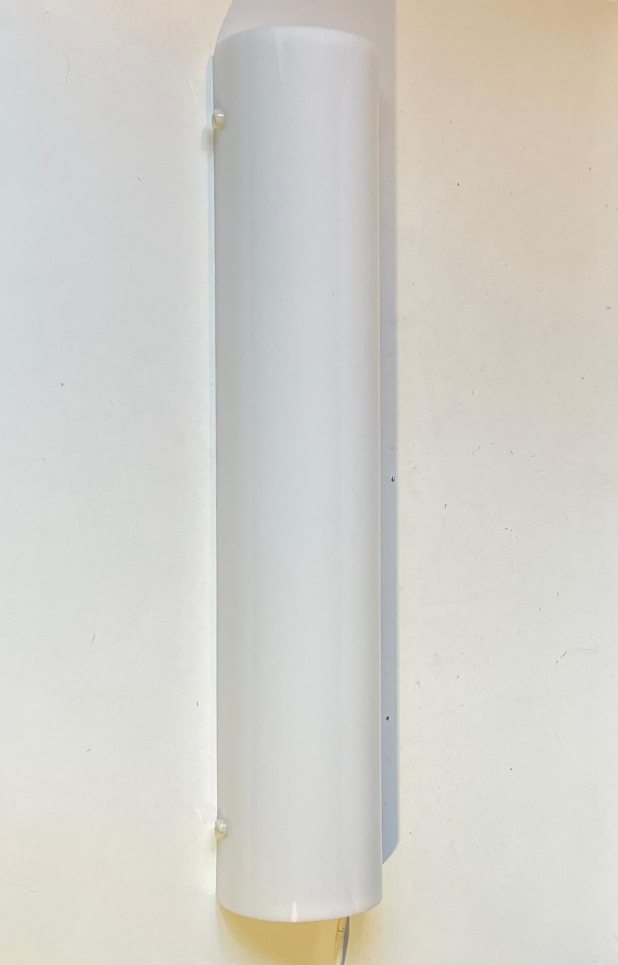 Eine architektonisch gestaltete, lange, röhrenförmige Leuchte, die sich als Badezimmer-, Empfangsraum- oder Spiegelbeleuchtung eignet. Sie ist aus gefaltetem weißem Luzit gefertigt, das das Licht sehr gut und mild verteilt. Es wurde von dem