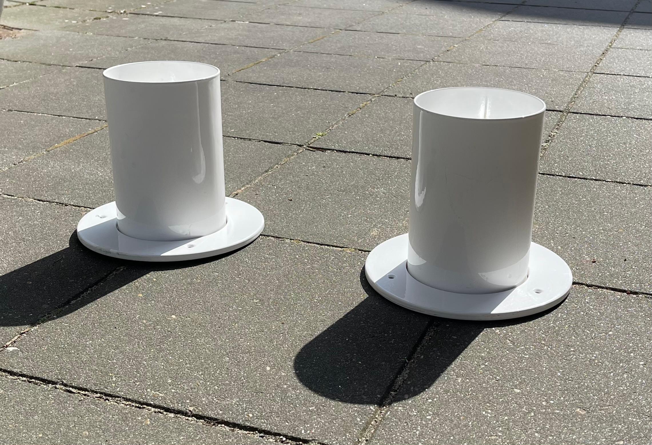 A pair of white built-on ceiling or flush mounts in powder coated metal. This design inspired by Gino Sarfatti was created by the Danish architect duo Friis & Moltke in the 1970s. The set comes all original with internal diffusers and porcelain