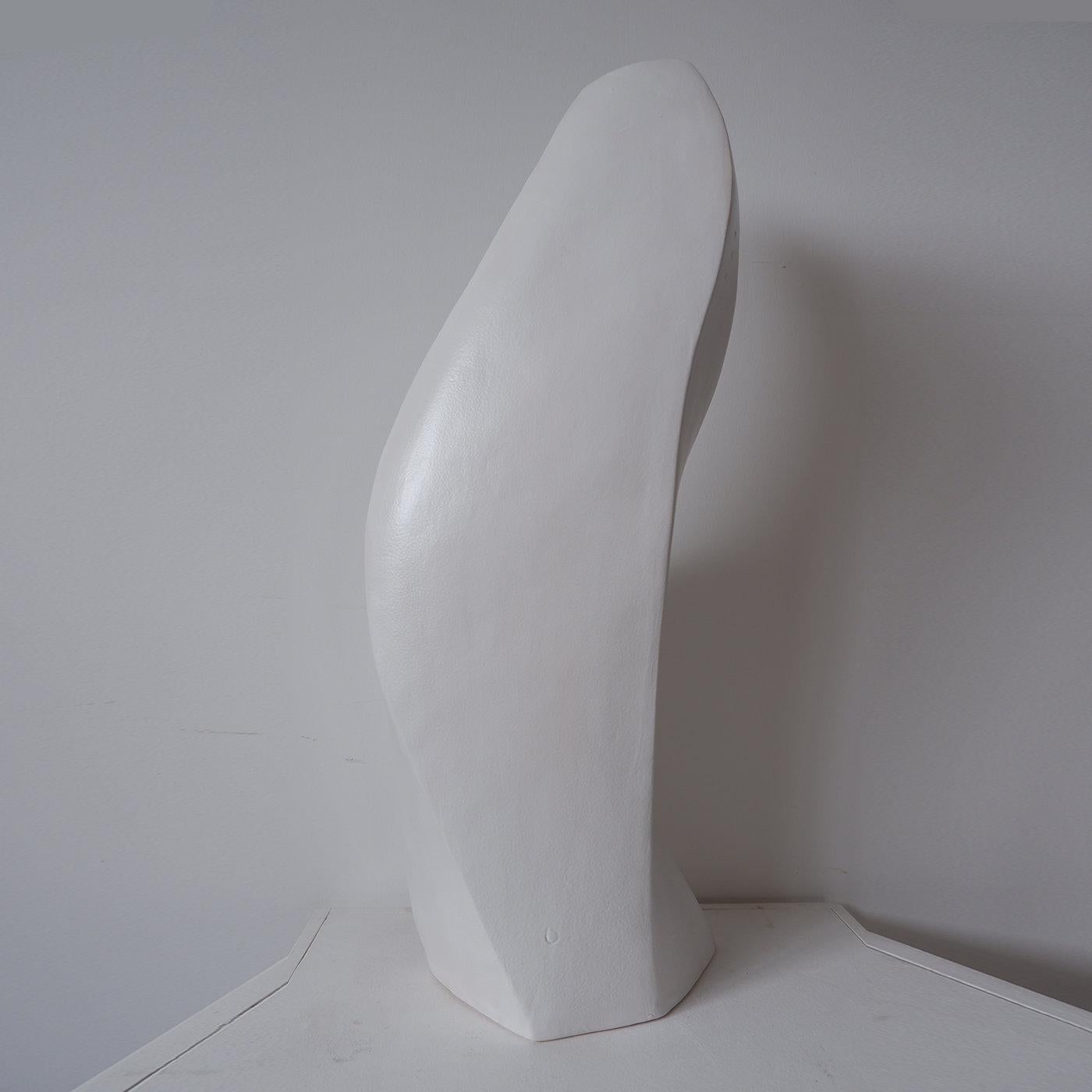 This vase represents the watery womb out of which blossoms the beauty of existence. It is inspired by the Greek goddess Demeter, who rules fertility, the seasons and the cycles of life. Its sleek, white ceramic design features an asymmetric, organic