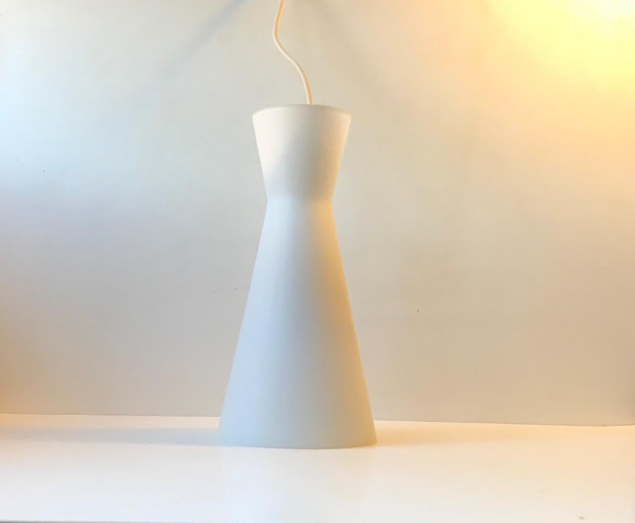 Diablo shaped pendant lamp in matté opaline glass. Designed and manufactured by Fog & Mørup in collaboration with Holmegaard in Denmark during the late 1950s. Two available. Price per 1 piece.