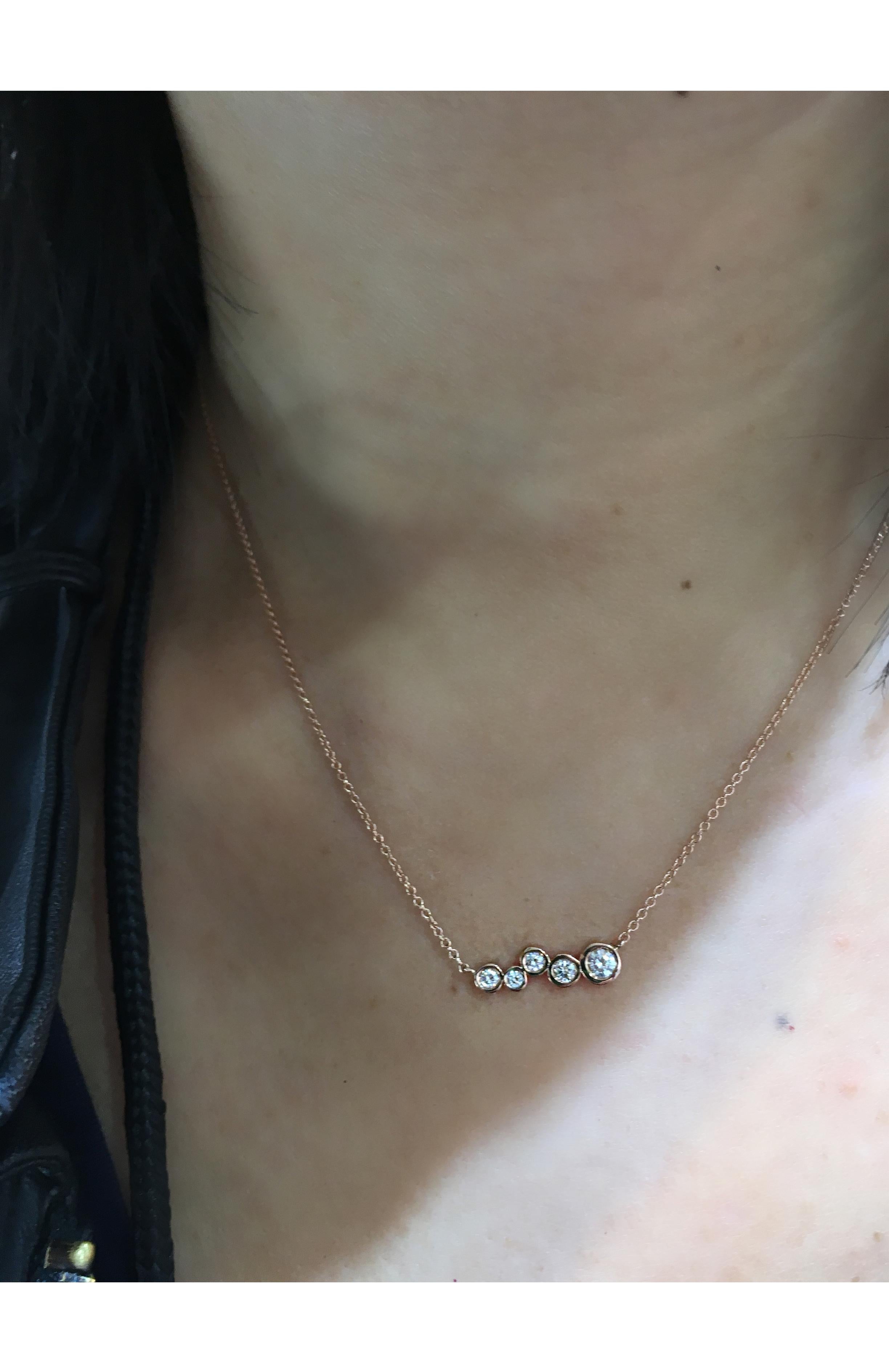 Our mini version of the classic bar pendant sprinkled with tapering sizes of diamonds.
Great for wearing on it's own or layering with your favorite necklaces! 

White Diamond Stones 0.27 cwt

Inspired by seeing the cross-section view of life, as if