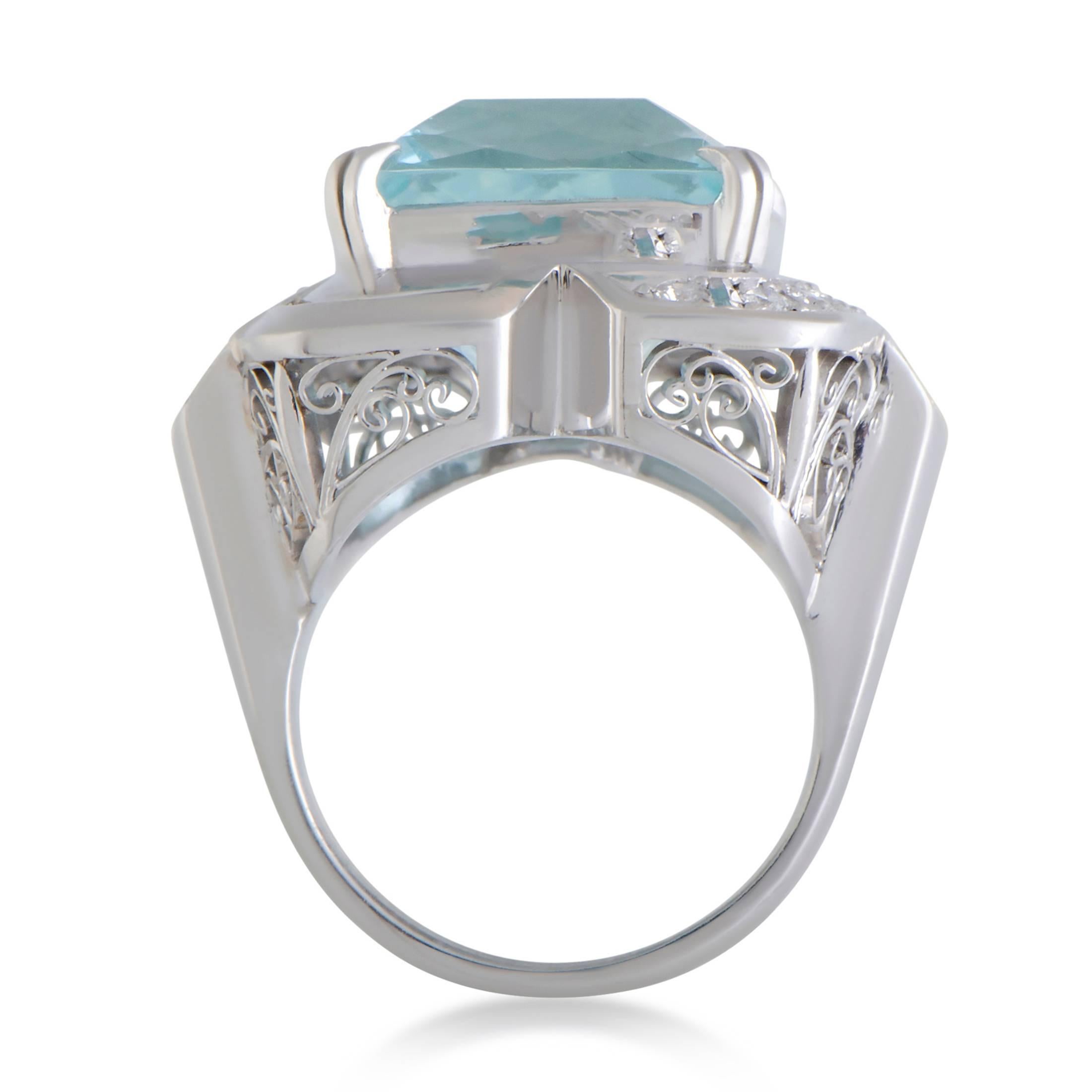 An incredibly bold and offbeat design is magnificently presented in platinum in this stunning ring that offers a compellingly fashionable appearance. The star of the show is a sublime aquamarine that weighs 12.94 carats and is accompanied by 0.29