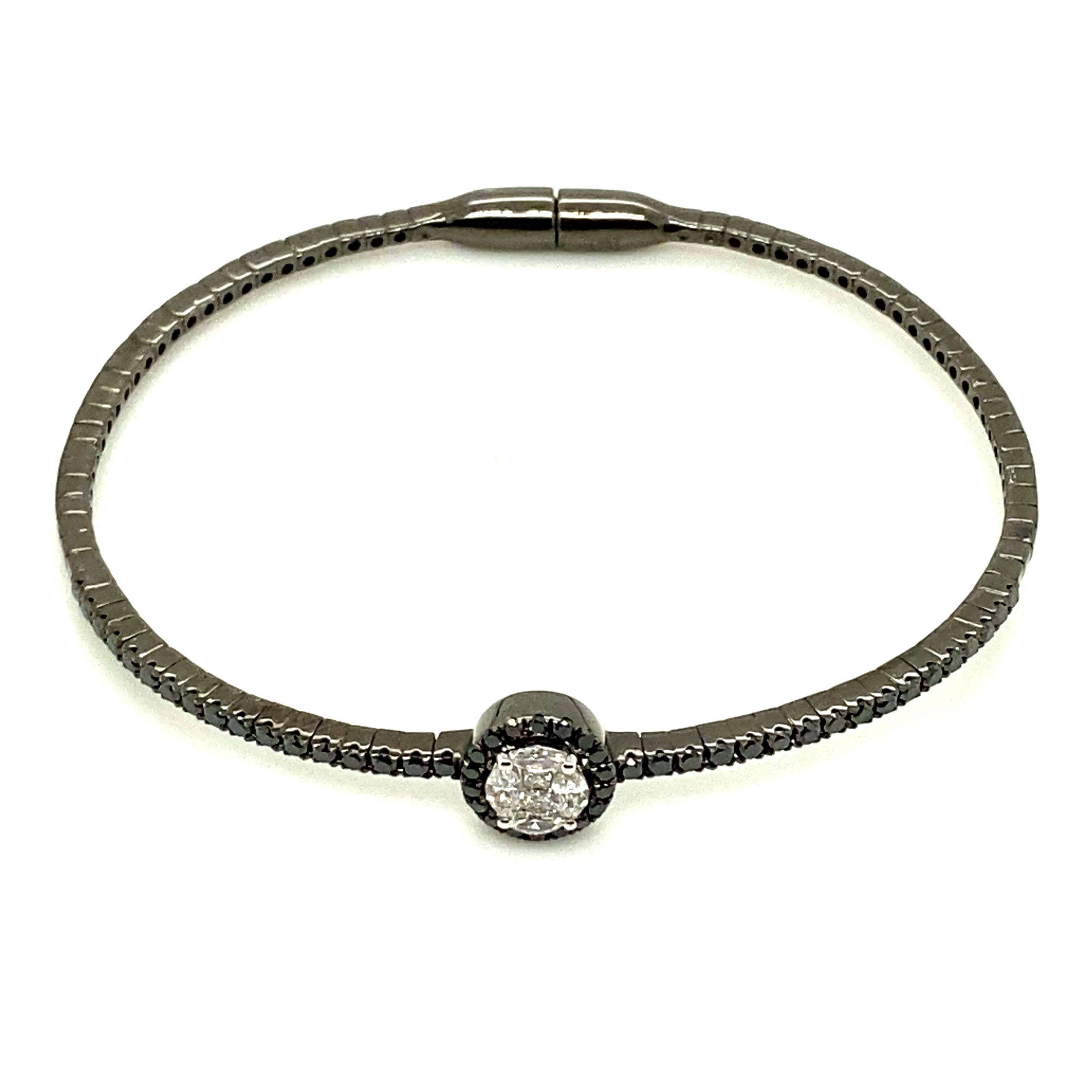 White Diamond and Blackened Gold Bracelet:

An elegant bracelet, it features a cluster of oval-shape diamonds weighing 0.89 carat situated in the centre of the bracelet. The diamonds are of fine quality and clarity. The design of the bracelet is