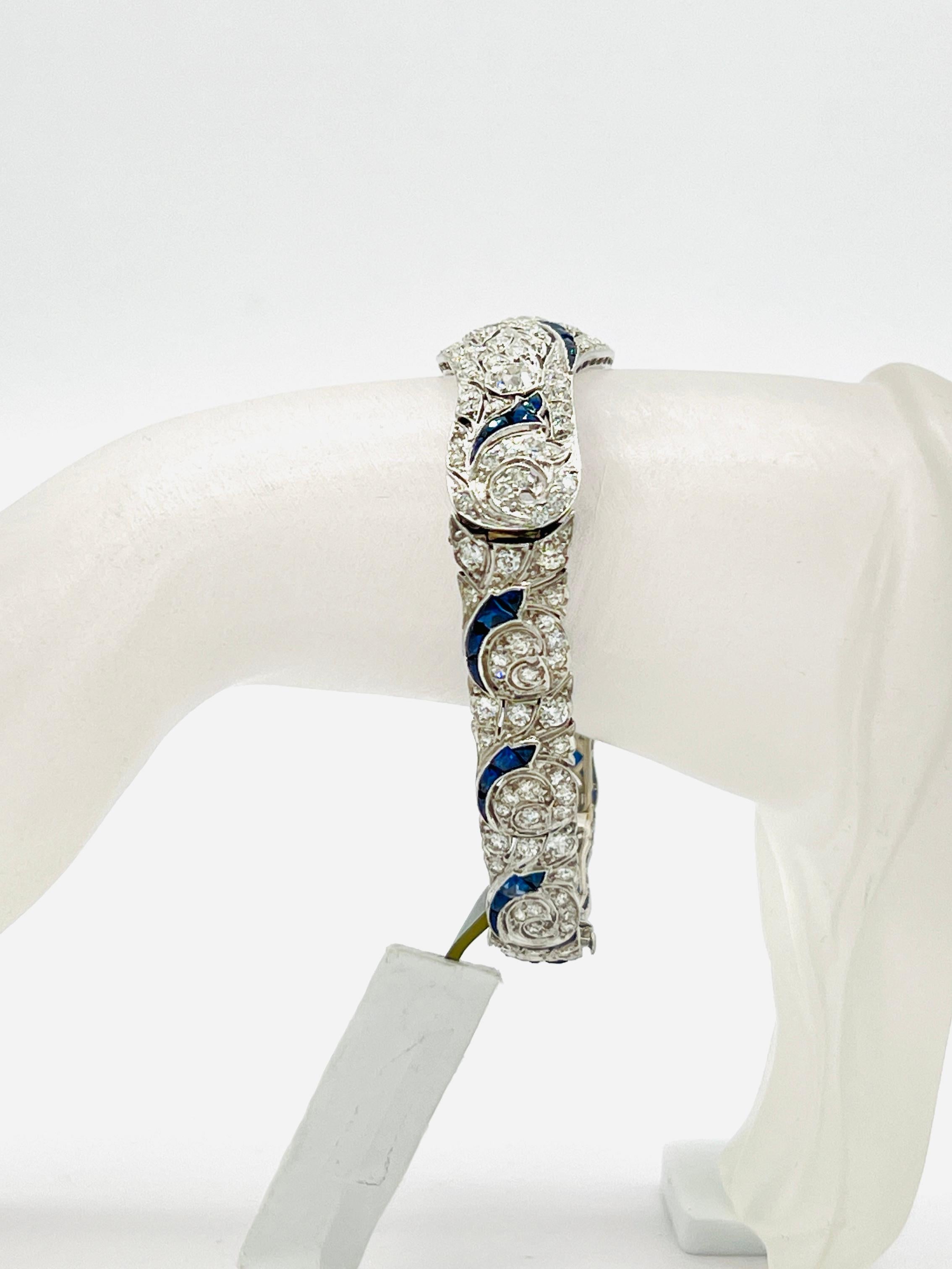 Stunning bracelet with a 1.40 ct. white diamond round center stone and 10.70 ct. blue sapphire and white diamond rounds.  Handmade in 18k white gold.  This piece would be a great addition to any fine jewelry collection!