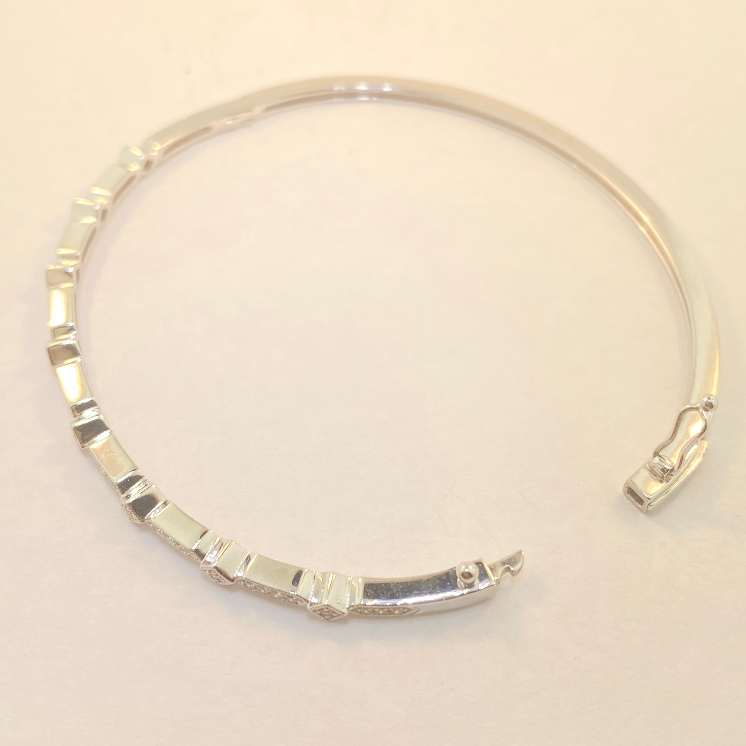 This precious bangle bracelet is dainty but such a stunning piece! It is made of solid 14 karat white gold with diamond embellishments on the top of the bangle!  The bracelet is really easy to put on as it has a hinge on one side and a hidden safety