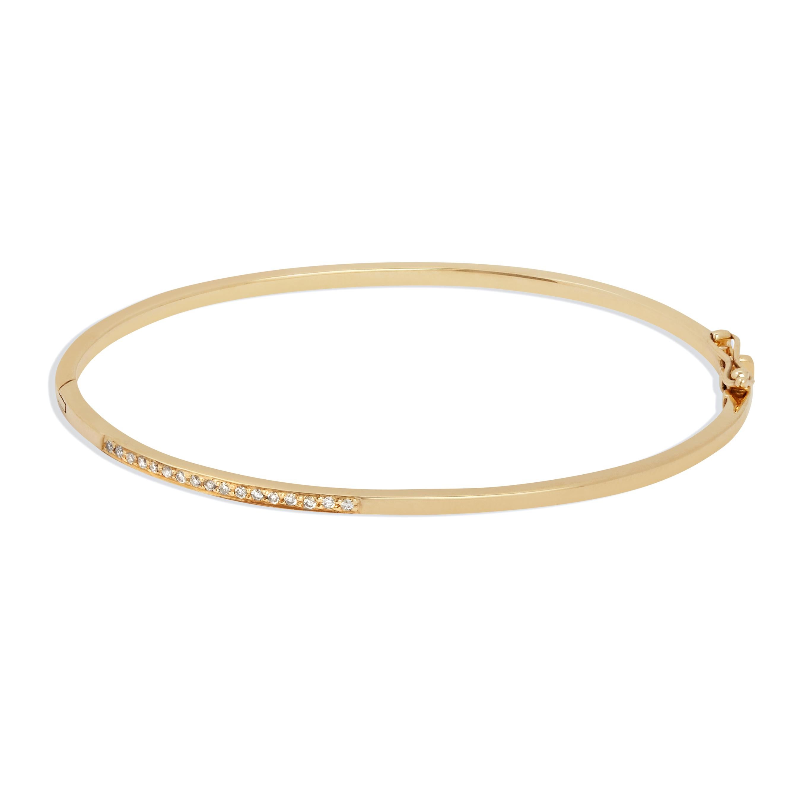 This clean-lined bangle features one inch of pave-set white diamonds.  The bracelet is crafted in solid 9-carat yellow gold with a discreet box clasp and figure-of-eight safety catch.

The black diamond accent features seventeen 1.2mm white diamonds