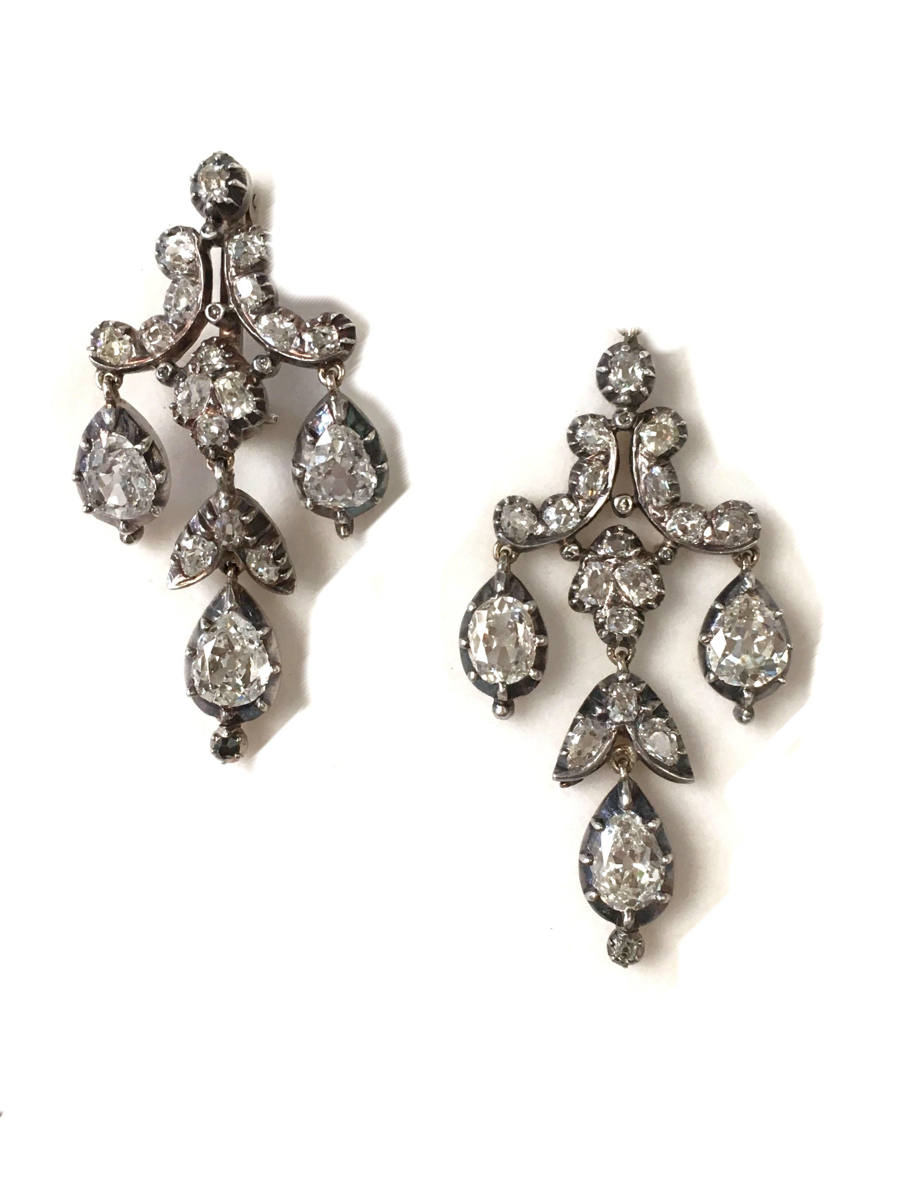 A pair of early 19th century chandelier drops set with diamonds. The diamonds set in silver cut down collet and silver setting work mounted on yellow gold backs. The pair are currently available as earrings with additional fixing to create a brooch