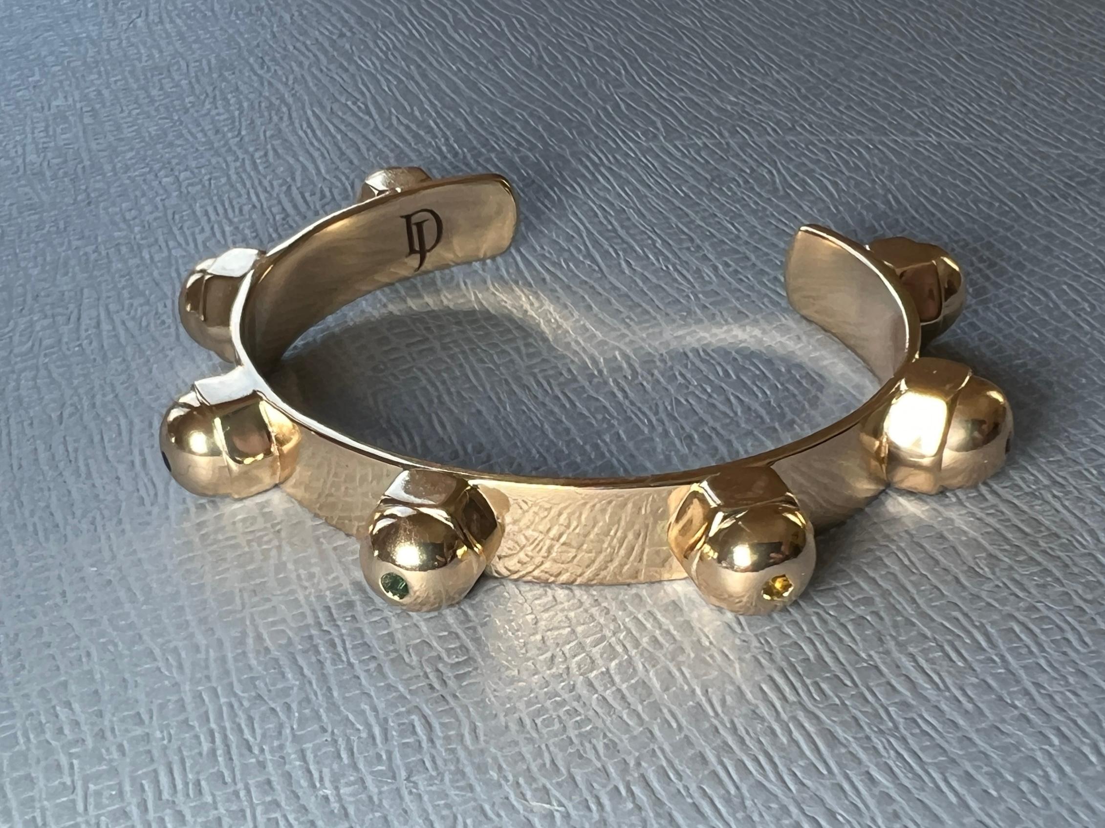 This gold-plated stud cuff bracelet by J Dauphin is a modern chakra jewelry piece featuring seven hand-set gemstones that align with the body’s energy centers. Designed as both a spiritual talisman and a statement bangle, it combines symbolic