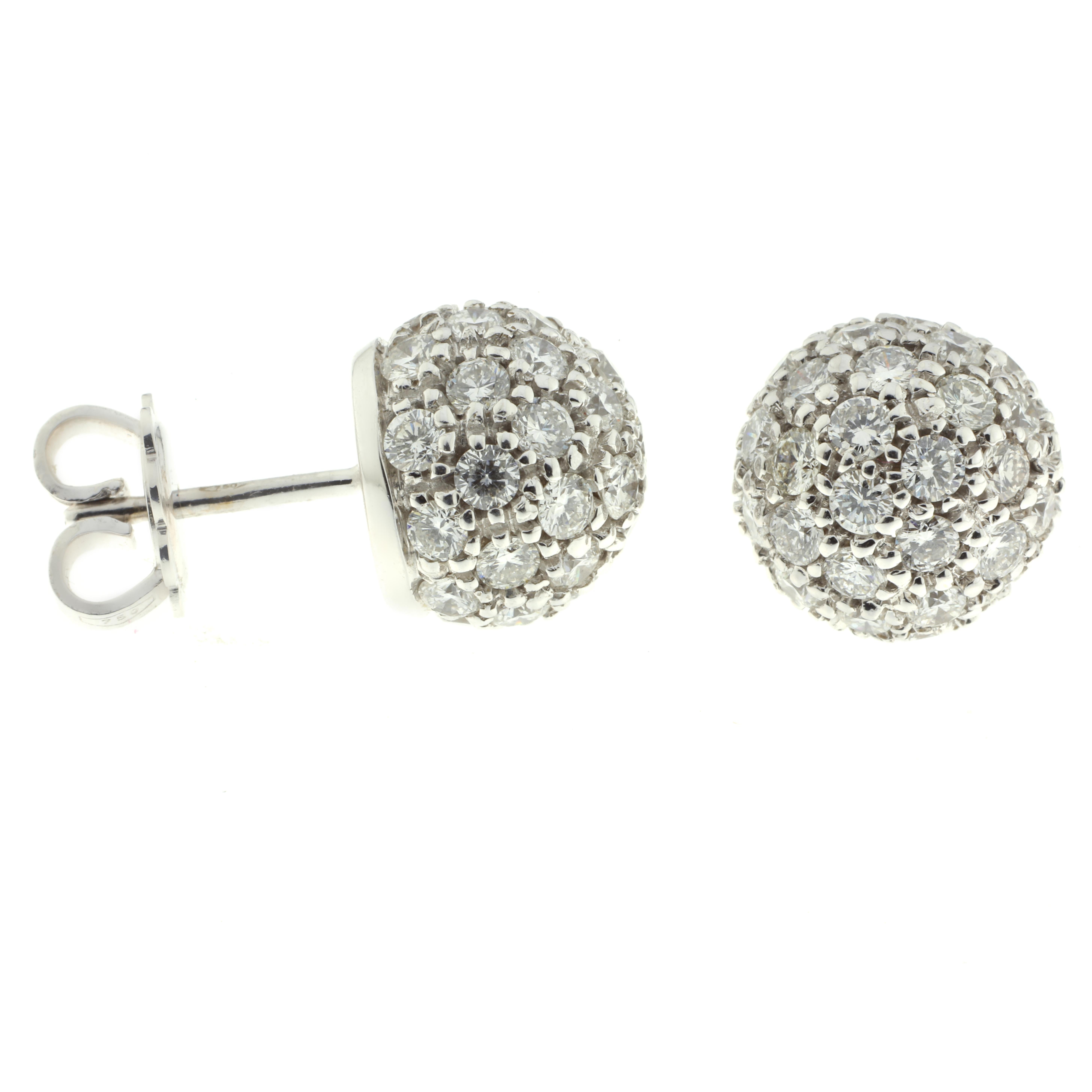 These earrings are a stunning 2.58 carats of white diamonds and 18-karat white gold. They have been masterfully handmade into a beautiful dome that is certain to catch and reflect light from any angle, drawing attention to the wearer with their