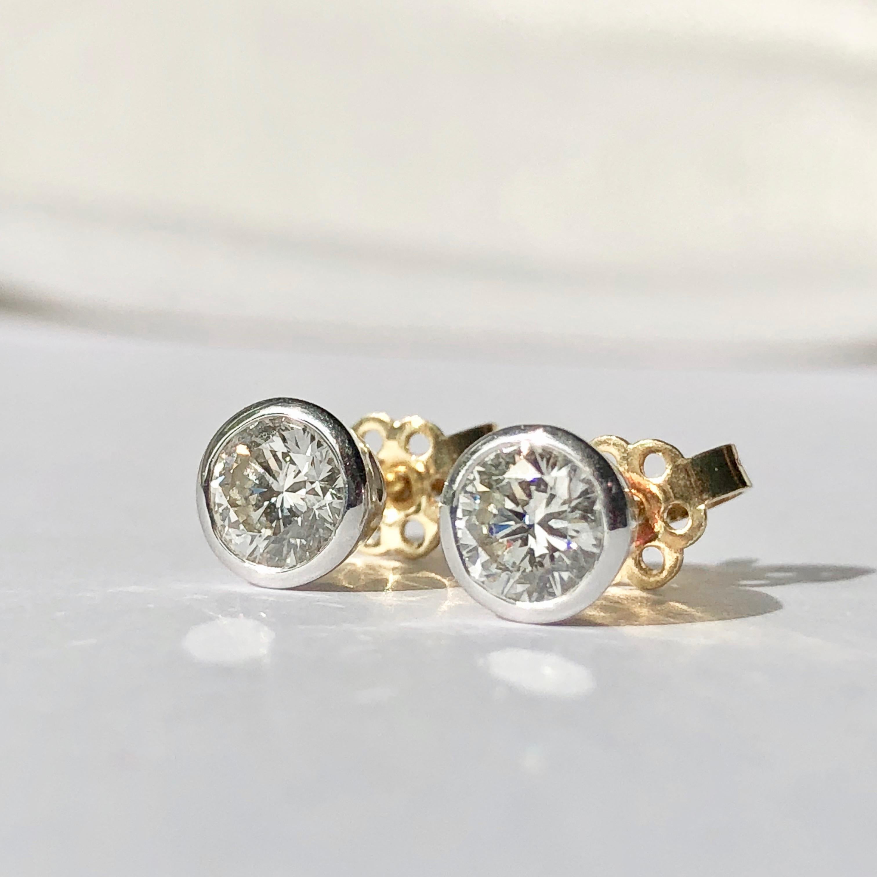 A Pair of Diamond Stud Earrings In Collet Setting

Each Diamond Weighs An Estimated .50ct Giving 1ct Total Weight 

The Diamonds Are Bright And Lively H Colour And VS/SI Clarity 

These Diamond Studs are White Gold Surround with Yellow Gold Posts -