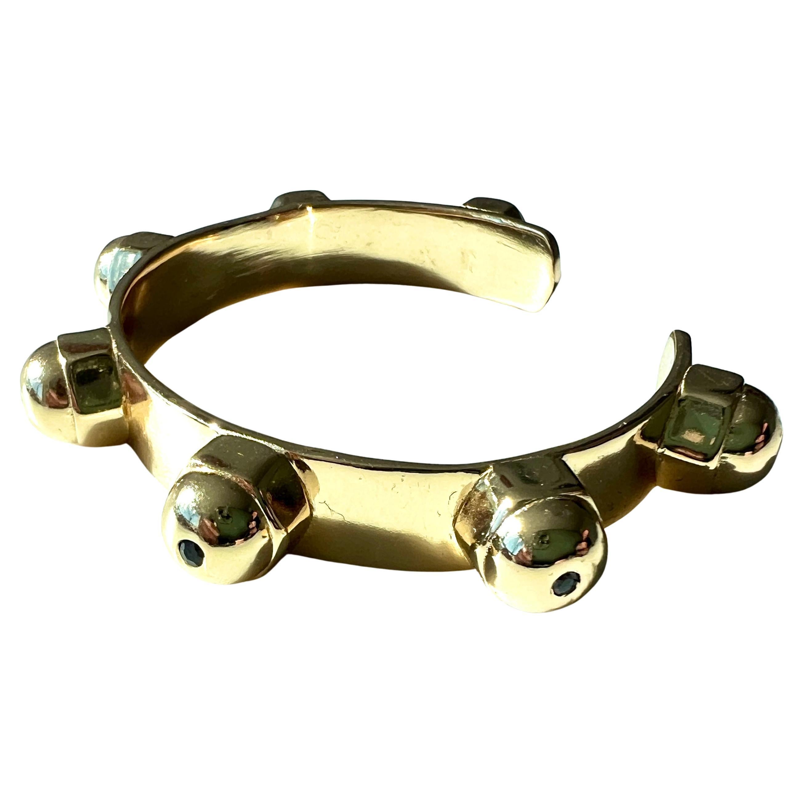 This gold-plated chakra cuff bracelet by J Dauphin is set with seven gemstones, each aligned with one of the body’s energy centers. Designed in a bold, sculptural style, this wide open bangle merges spiritual alignment with modern minimalism.

The