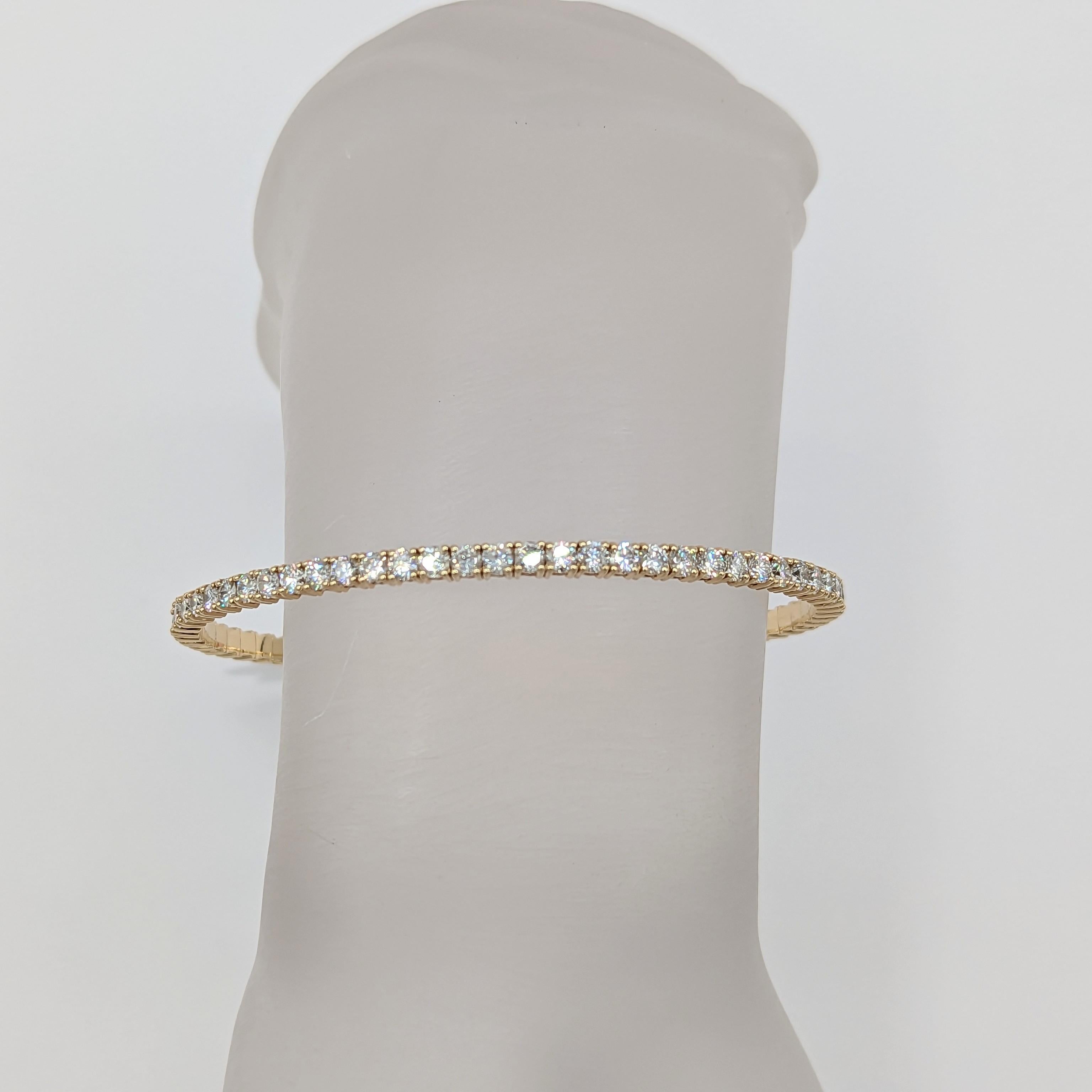 Beautiful 5.05 ct. white diamond rounds.  Handmade in 14k yellow gold.  This bangle is unique because it is flexible, making it more comfortable to wear.  