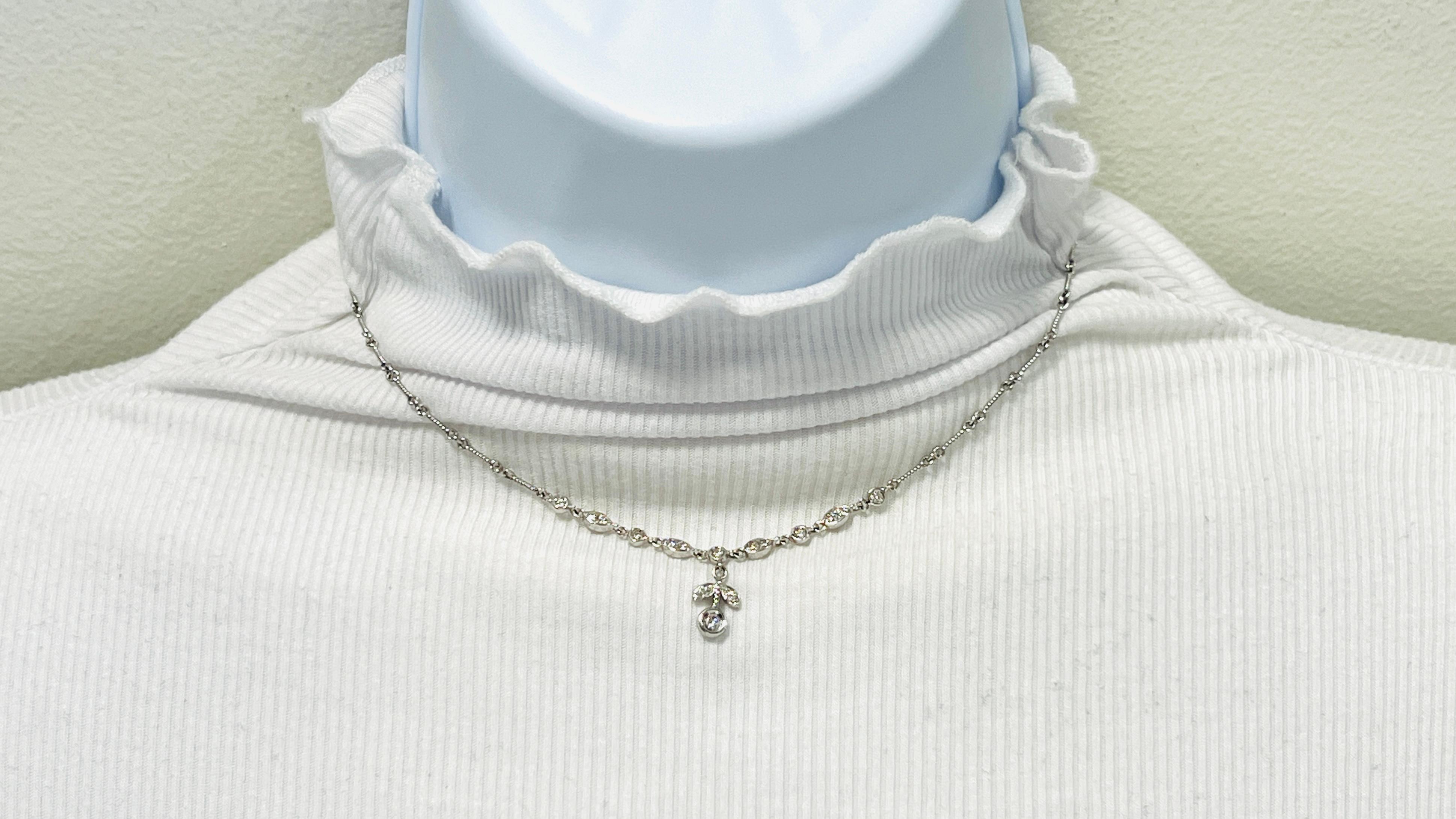 Beautiful floral necklace with 0.50 ct. good quality white diamond rounds.  Handmade in 18k white gold.  Length of chain is 14