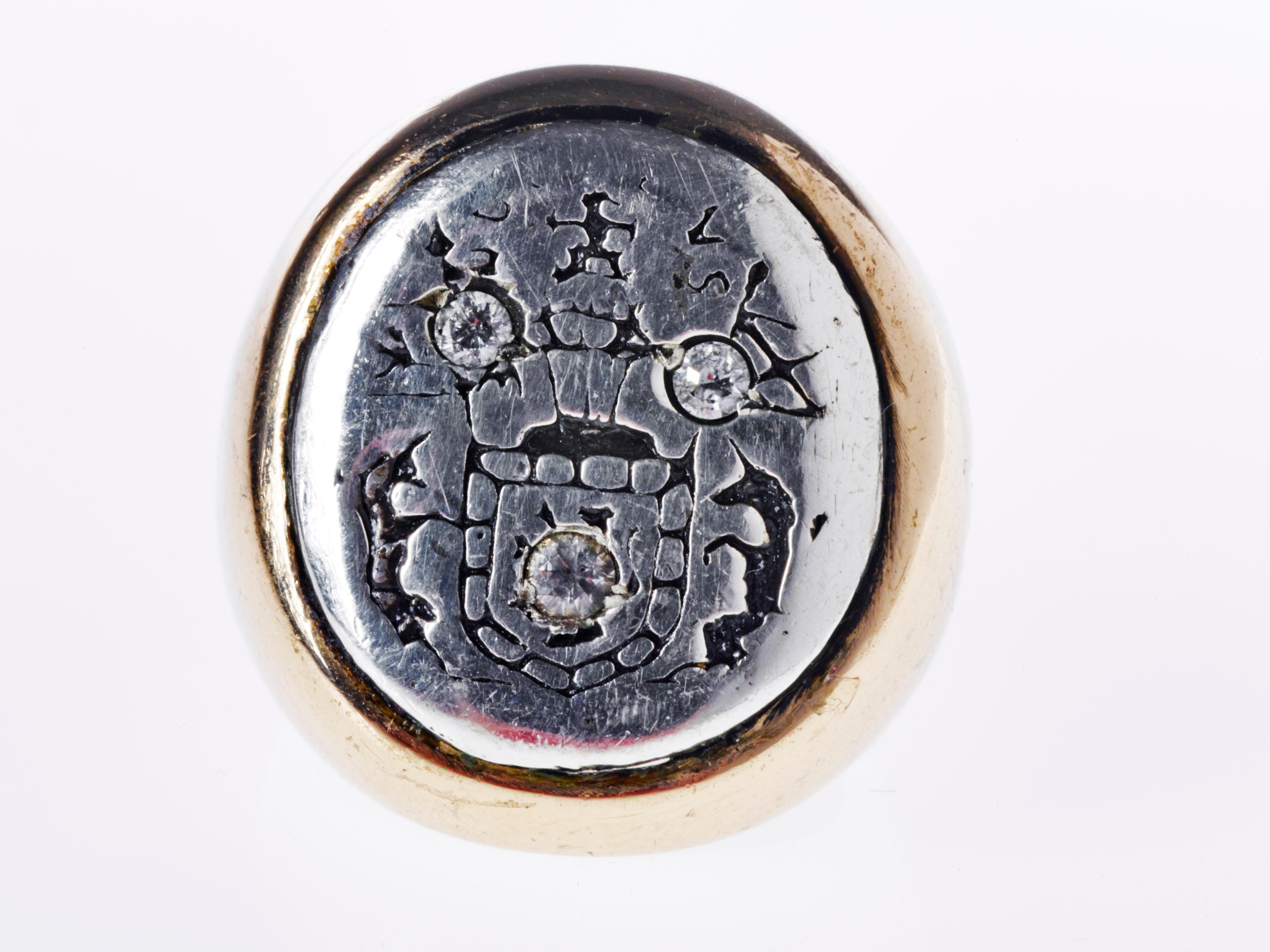 White Diamond Crest Signet Ring  14k Yellow and White Gold J Dauphin

Inspired by Queen Mary of Scots ring. Gold signet-ring; engraved; shoulders ornamented with flowers and leaves. Oval bezel set with silver intaglio depicting achievement of Mary