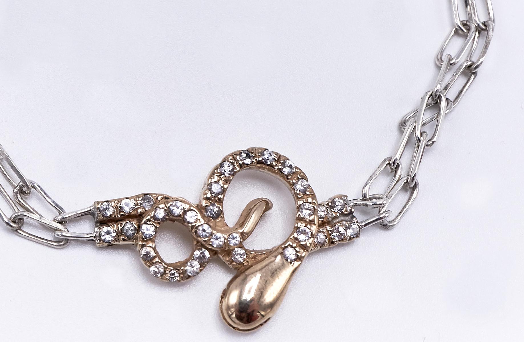 Collana a catena con diamante bianco e serpente d'oro, girocollo di rubino, catena d'argento e ciondolo d'oro

J DAUPHIN 