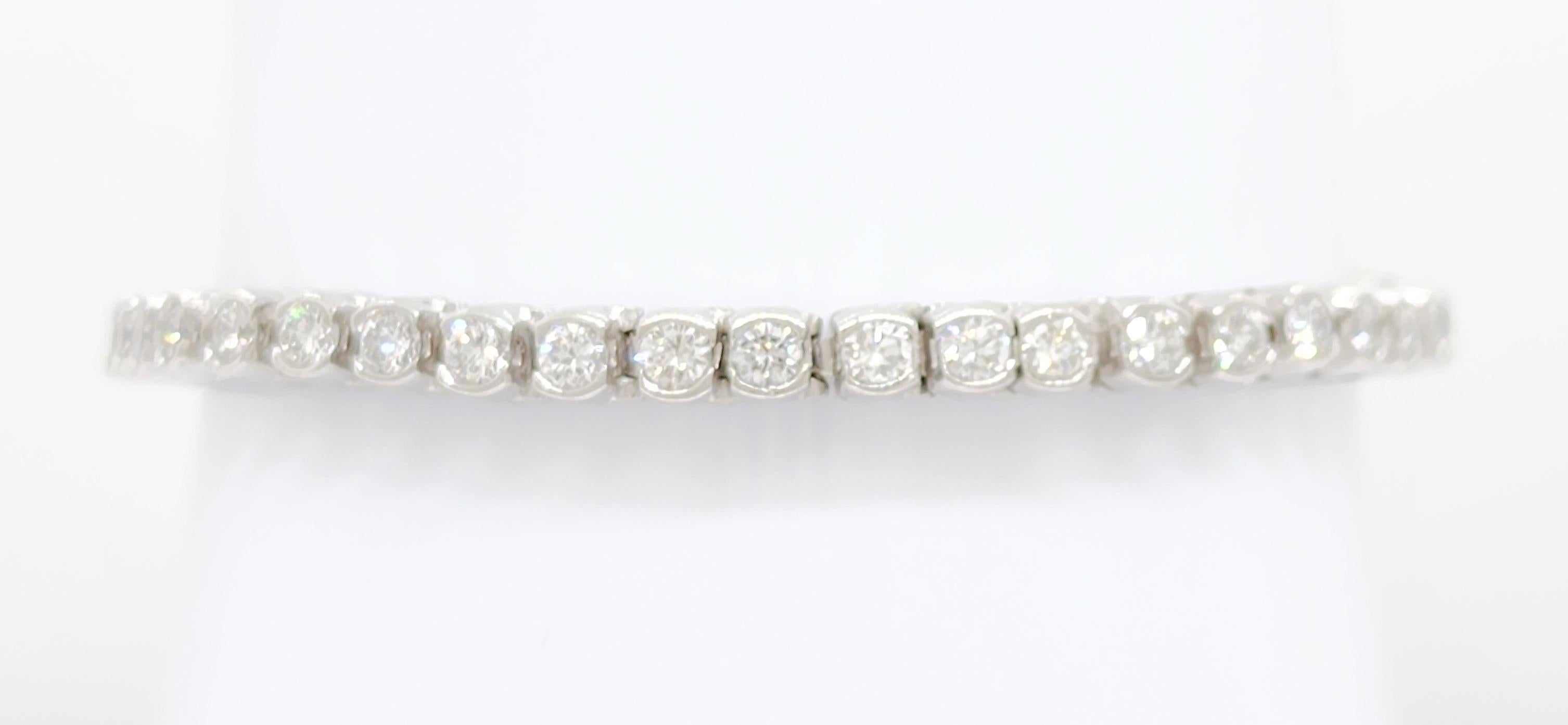 Beautiful 3.00 ct. white diamond rounds in a handmade 14k white gold mounting.  Half bezel set diamonds give this bracelet a different look than the traditional prong set diamonds in a tennis bracelet.  Great for layering or wearing on its own.