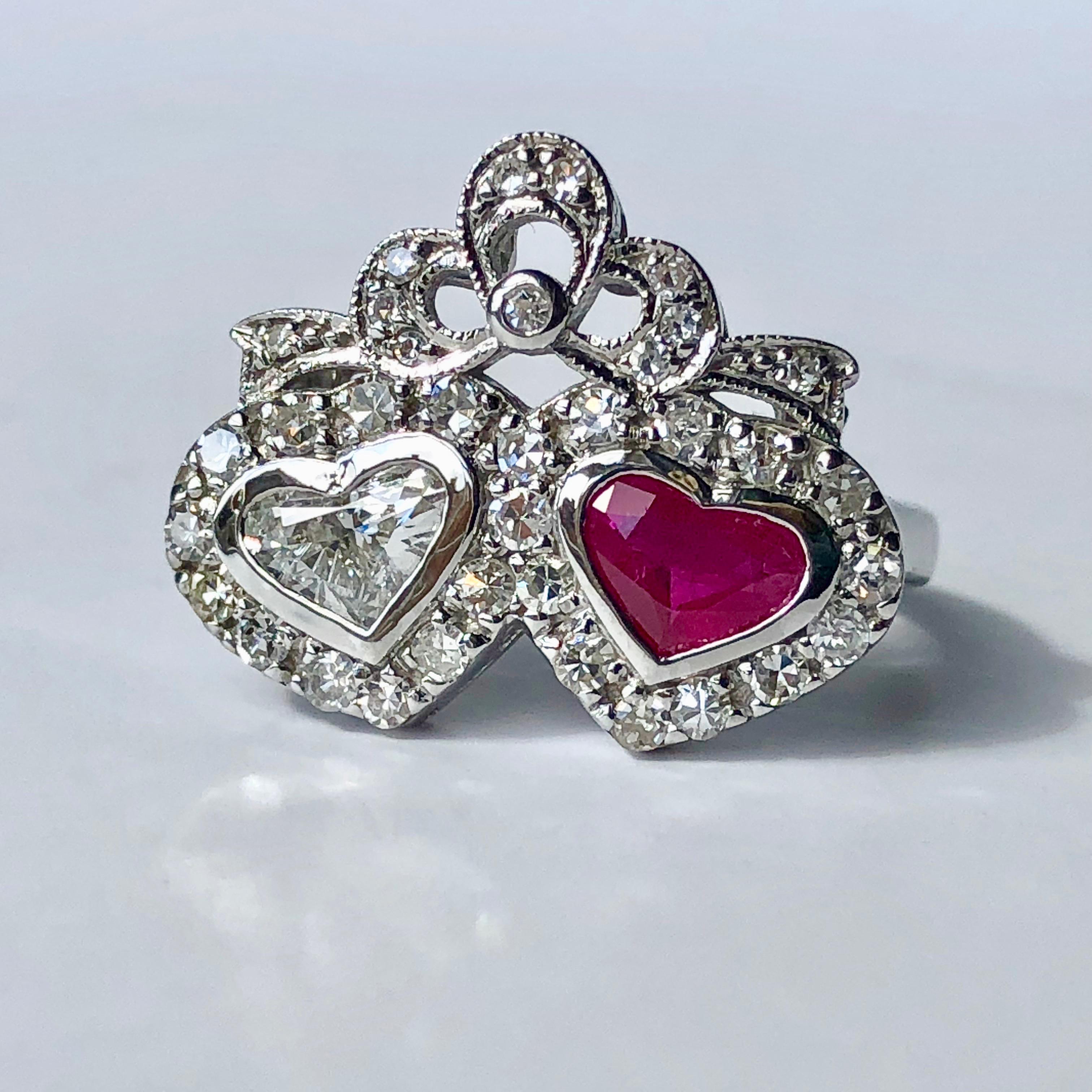 A Beautiful Twin Hearts Ring, Love Entwined. Possibly Irish.

Total Diamond Weight .80ct Est

Set with one heart shaped Ruby and one heart shaped Diamond with a diamond surround and diamond set bow detail

An ideal gift for an anniversary, for