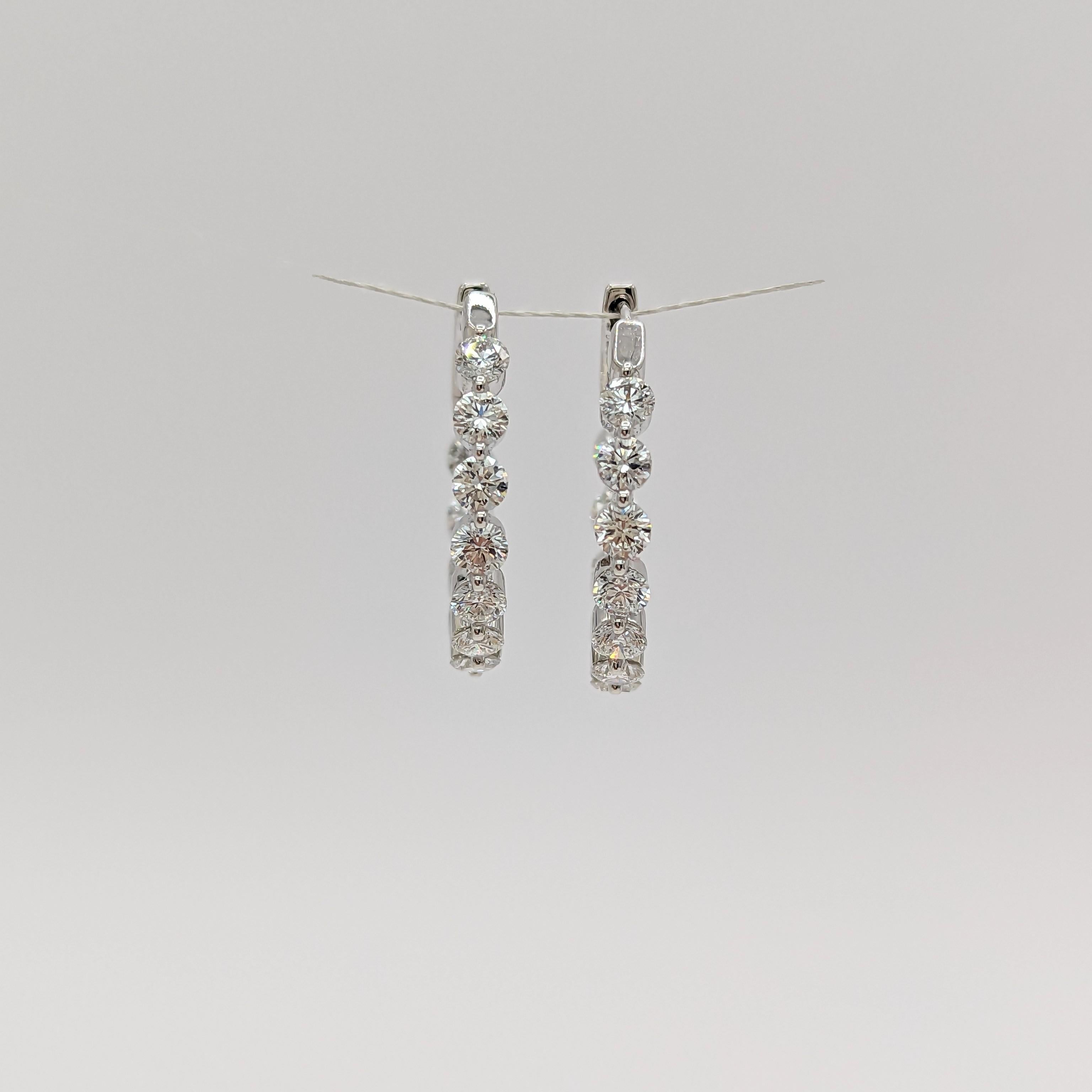 Beautiful hoop earrings with 3.23 ct. white diamond rounds.  Handmade in 18k white gold.  Diamonds are set inside and outside, giving the hoops a more elevated look.
