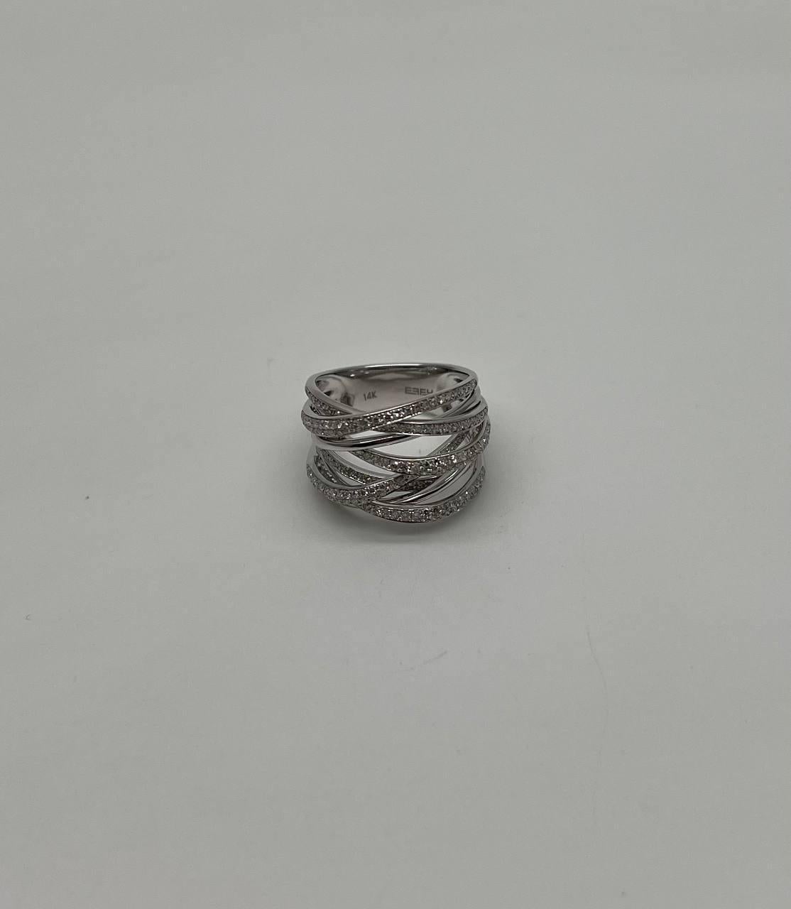 This captivating piece, made in 14K white gold, features a sophisticated design with multiple intertwined bands. Each band is adorned with pavé-set diamonds, creating a shimmering effect that catches the light beautifully.
The intricate crisscross