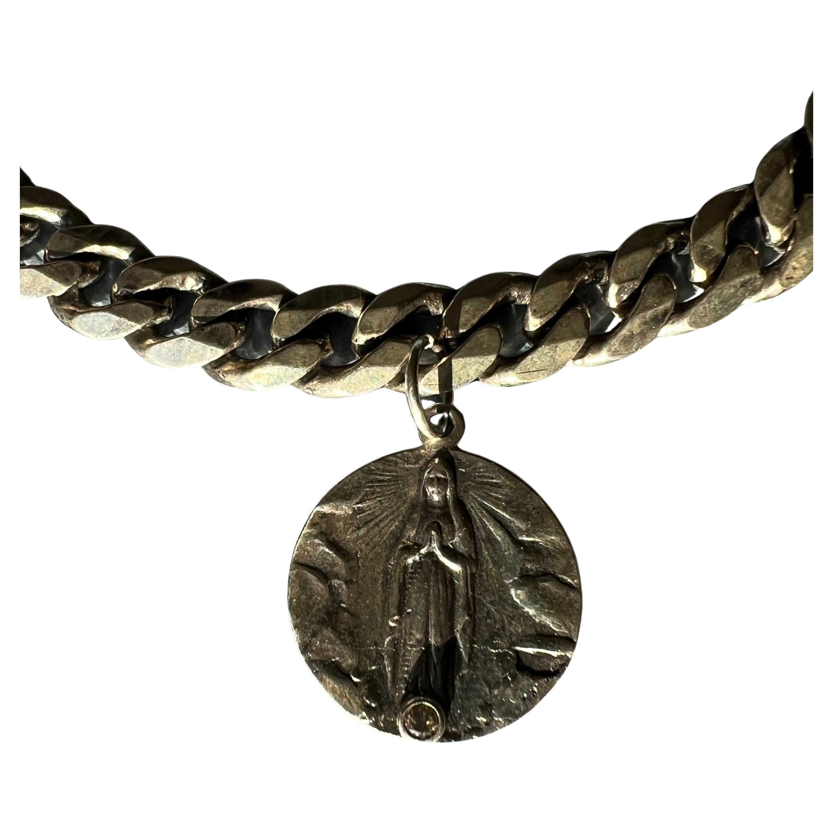 White Diamond Medal Silver Virgin Mary Choker Chain Necklace

Length: 16 inches

In the broader context of Catholic iconography, the medals encourage a personal and protective connection to the divine, reflecting a heritage of faith that is both