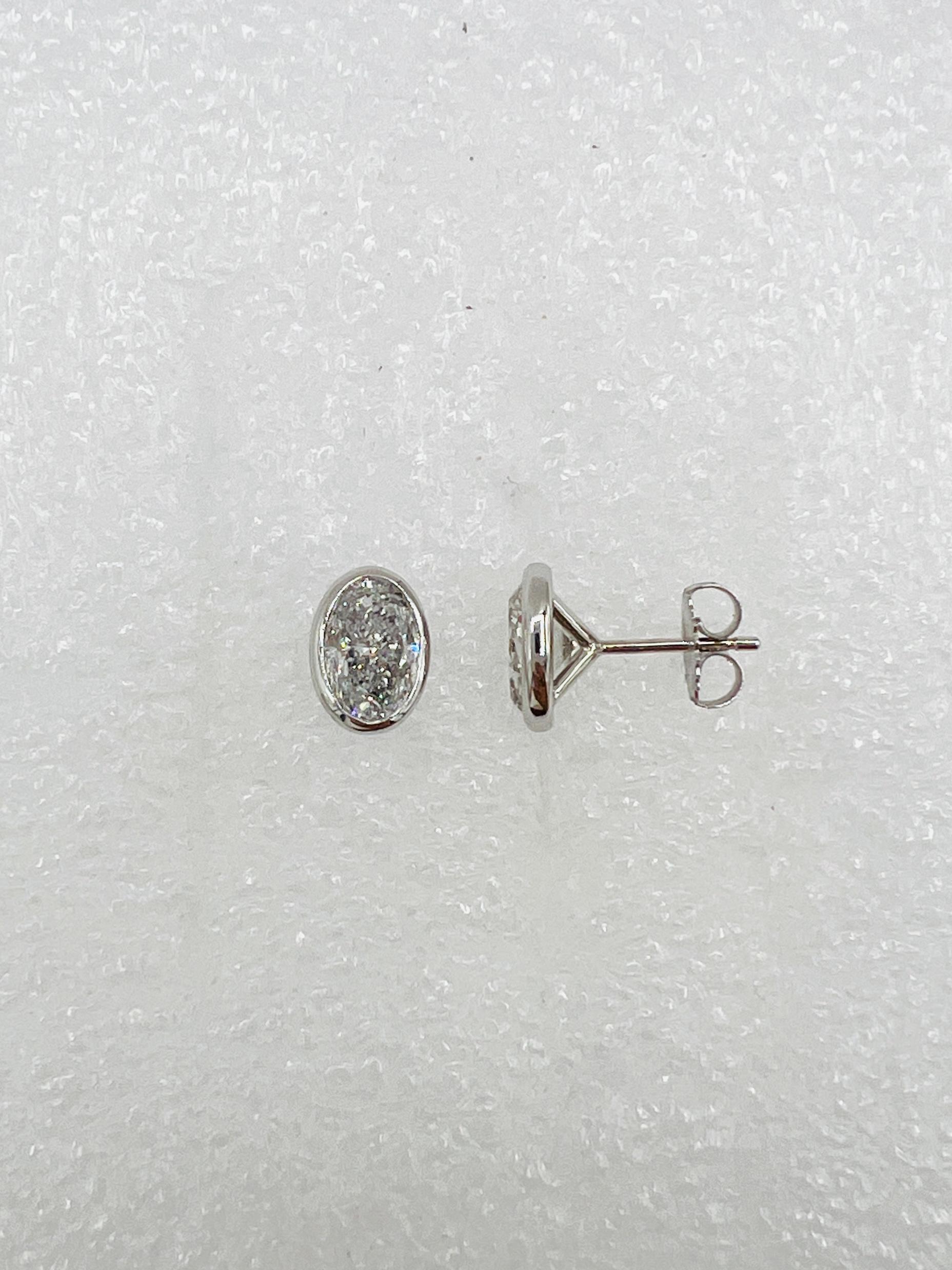Women's or Men's White Diamond Ovals 1.50 Carat Each Bezel Stud Earrings in 18K White Gold For Sale