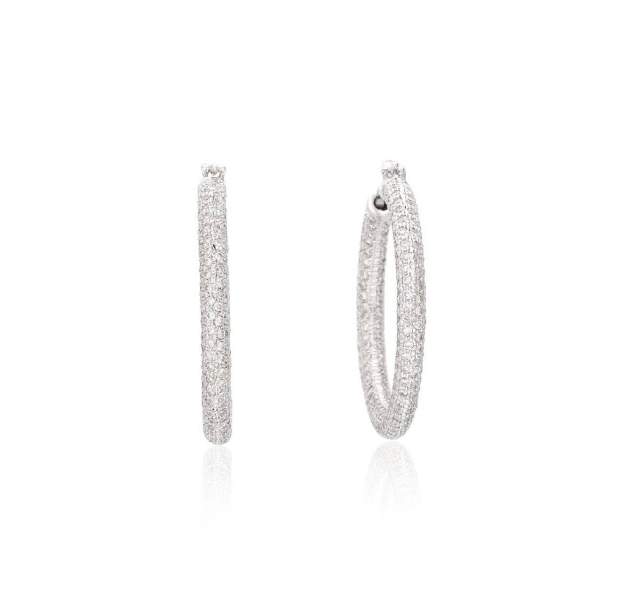 Gorgeous and Unique Diamond Pave Hoops beautifully handmade in 18K white gold.

The details are as follows :
Diamond weight : 5.65 carats with HI color and SI clarity
Metal : 18k white gold
Measurements : Length : 1 1/2 inches and width : 1/8