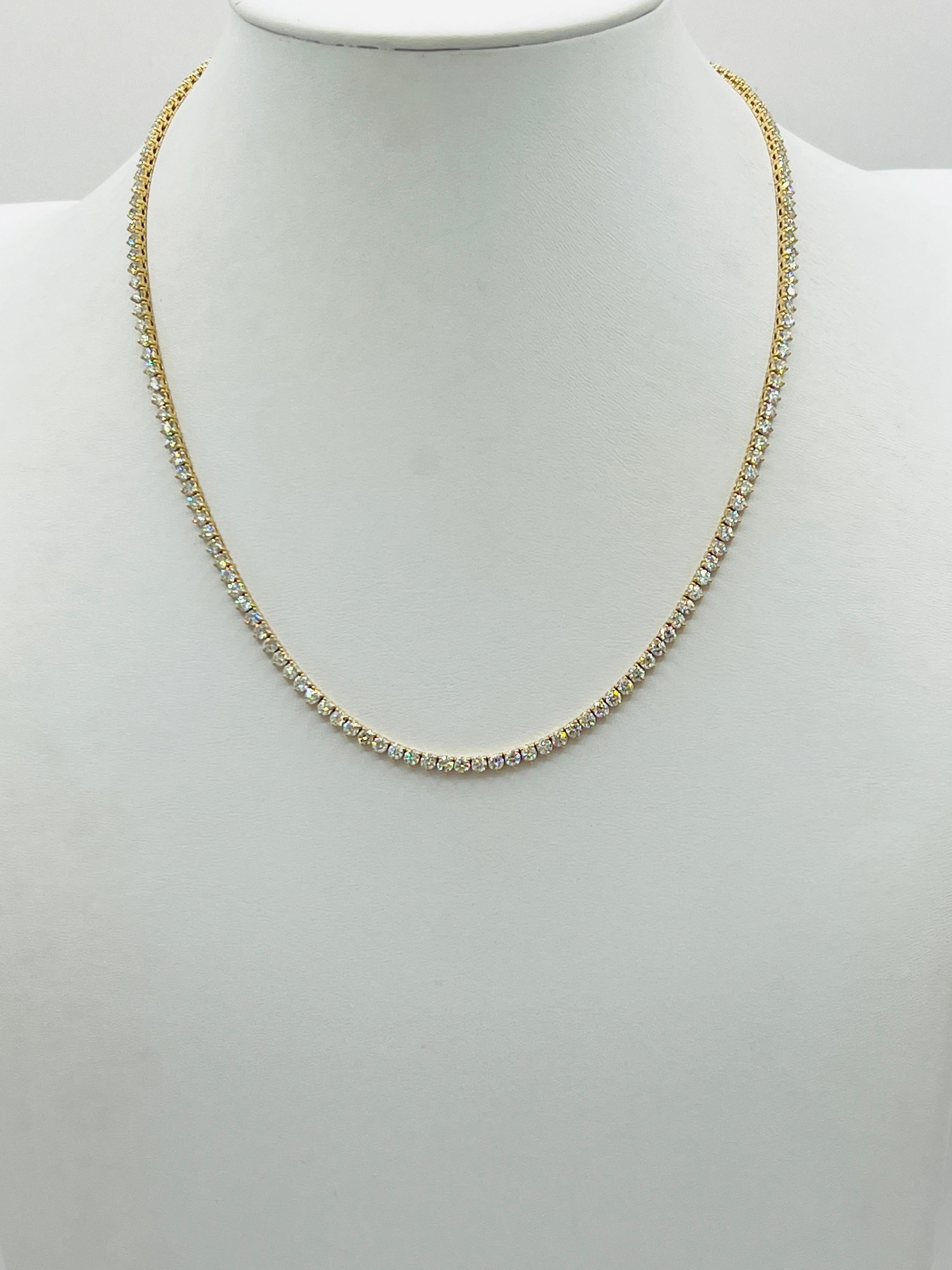 Beautiful 6.18 ct. good quality, white, and bright diamond rounds.  Handmade in 14k yellow gold.  Three prong setting.  Length is 17